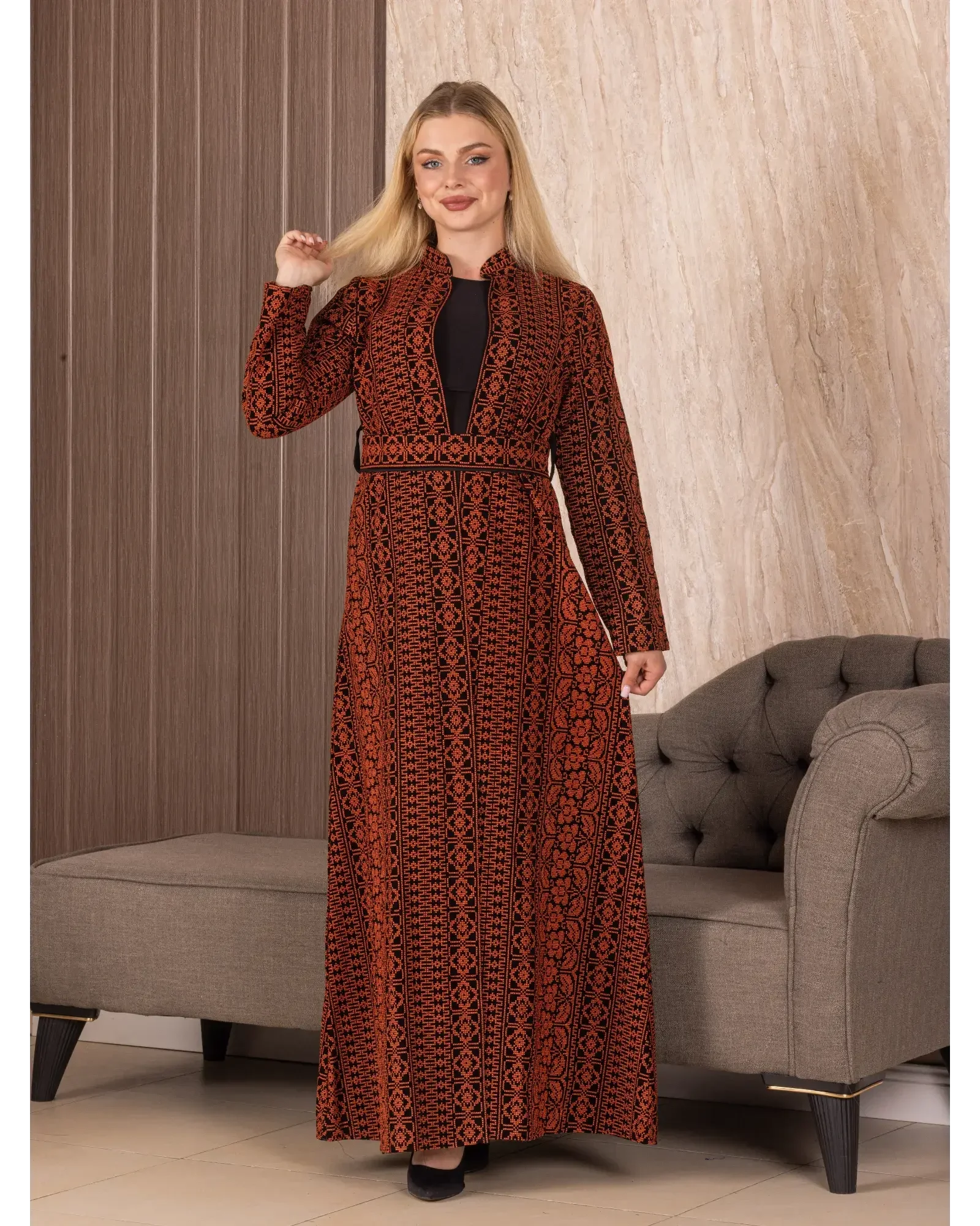 Palestinian Elegance embroidered long cardigan in red and black with intricate patterns worn by woman