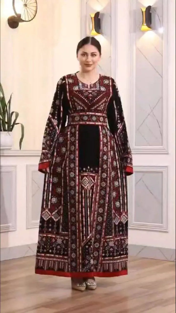 Palestinian Elegance embroidered manjal thoub dress with intricate red and white patterns on black fabric