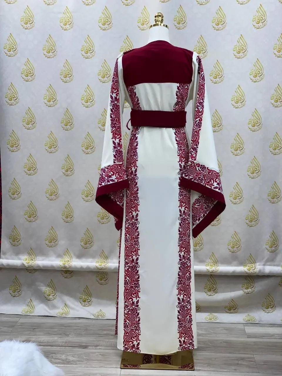 White and burgundy embroidered modest fashion dress with intricate red floral embroidery by Palestinian Elegance