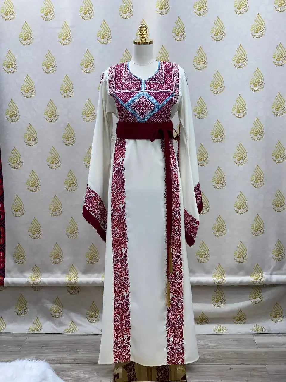 Embroidered modest fashion dress with intricate red and blue embroidery from Palestinian Elegance