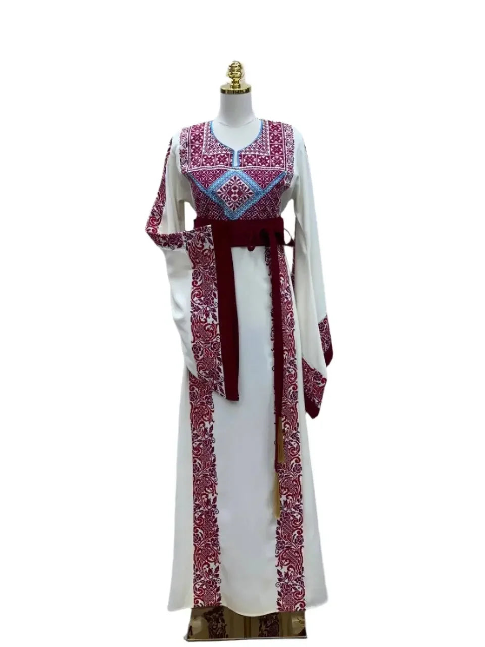 Palestinian Elegance embroidered modest fashion dress with intricate red and blue embroidery on white fabric