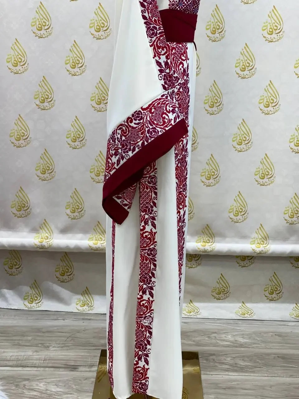 Palestinian Elegance embroidered modest fashion dress with intricate red embroidery on white fabric
