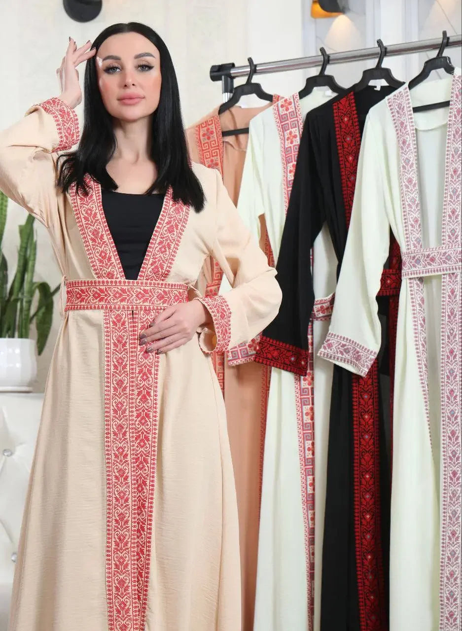 Embroidered open cardigan with red traditional patterns worn by woman next to similar cardigans in various colors
