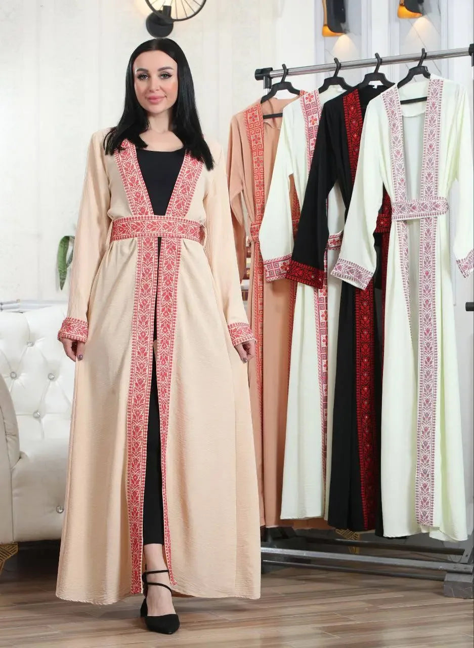 Palestinian Elegance embroidered open cardigan in beige with traditional red embroidery worn over black outfit
