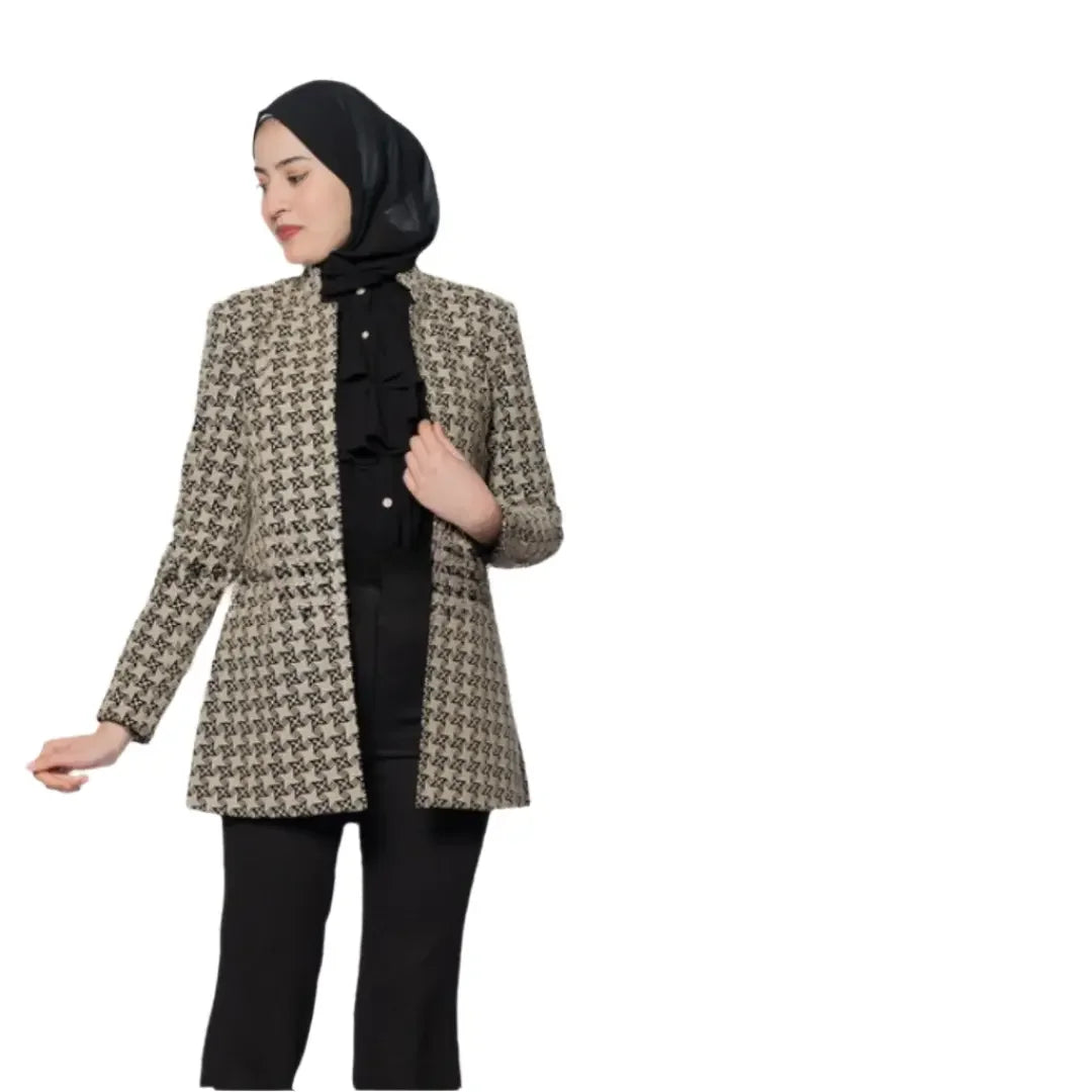 Woman wearing embroidered Palestinian blazer from Palestinian Elegance with black hijab and black pants