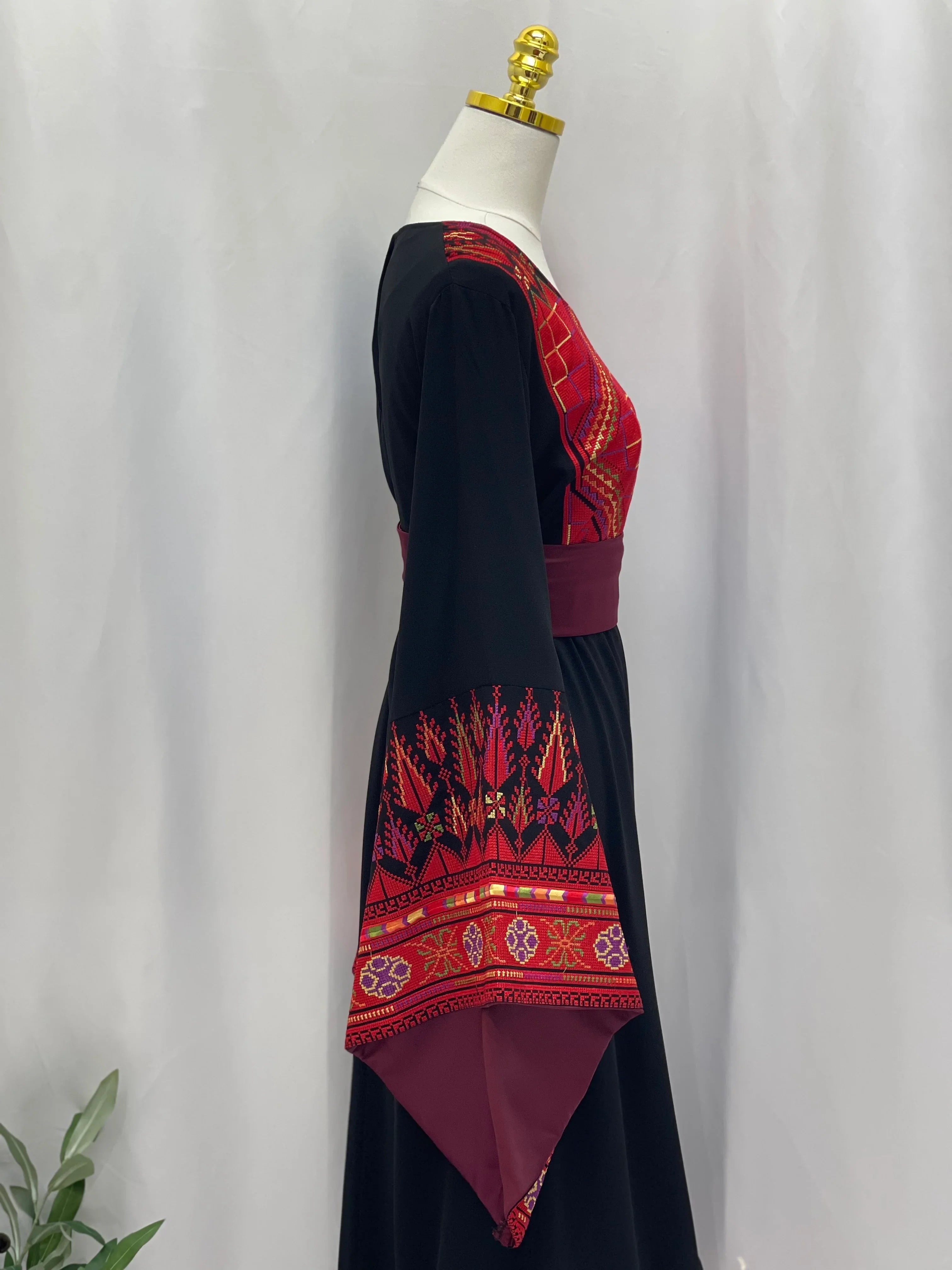 Black embroidered Palestinian thoub dress with red intricate traditional embroidery on sleeves and chest