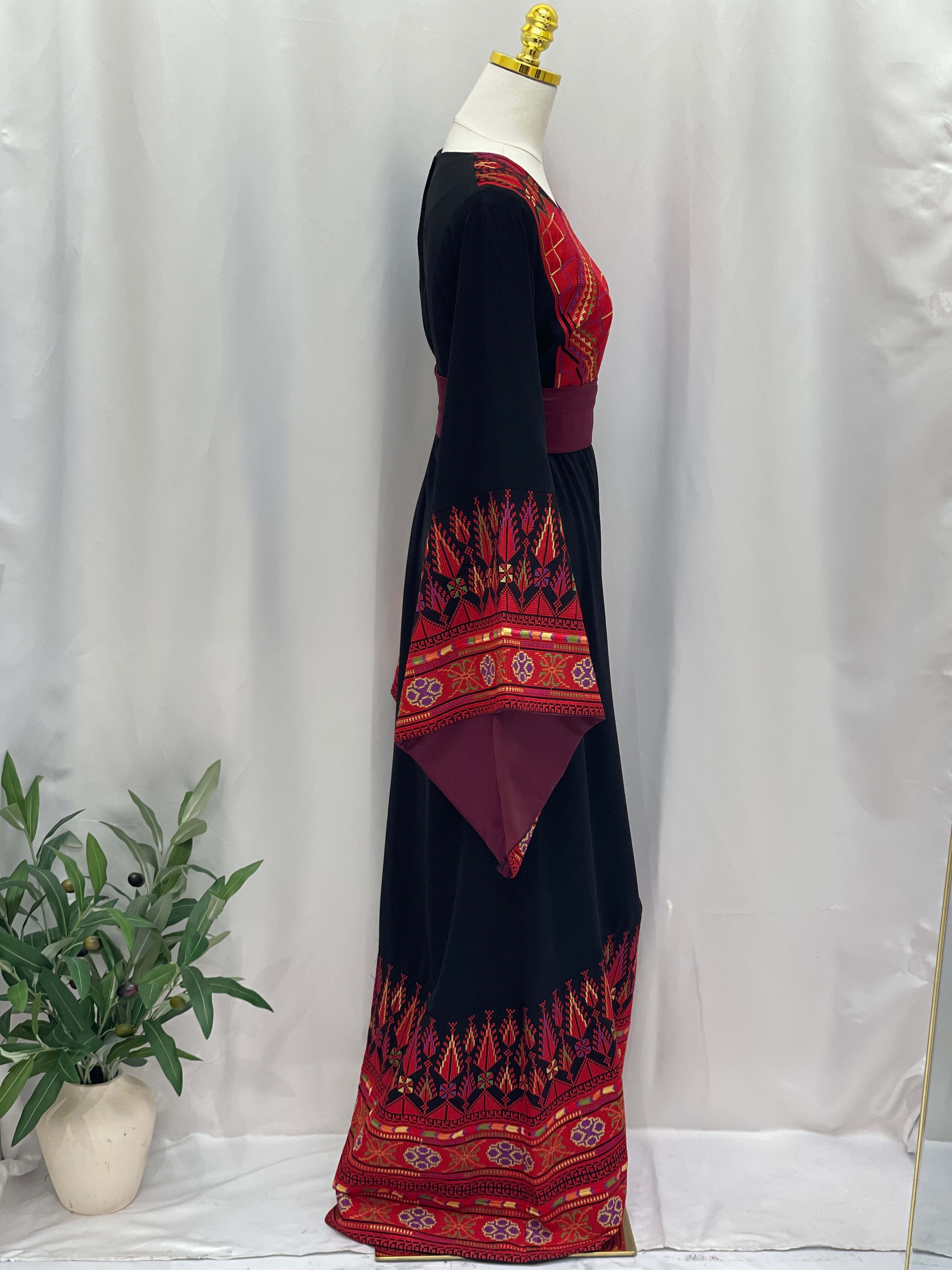 Embroidered Palestinian thoub dress in black with red traditional patterns by Palestinian Elegance