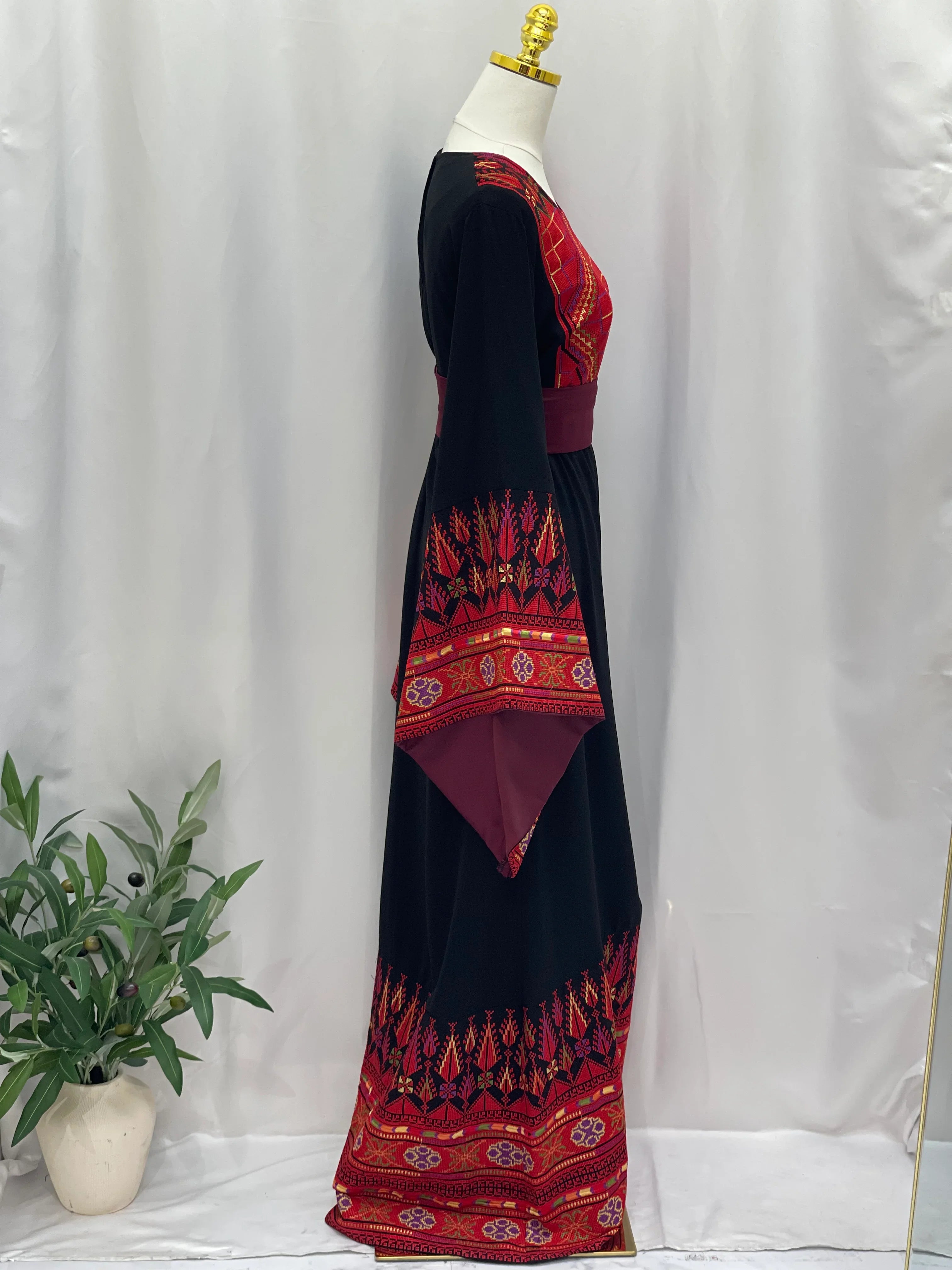 Embroidered Palestinian thoub dress in black with red traditional patterns by Palestinian Elegance