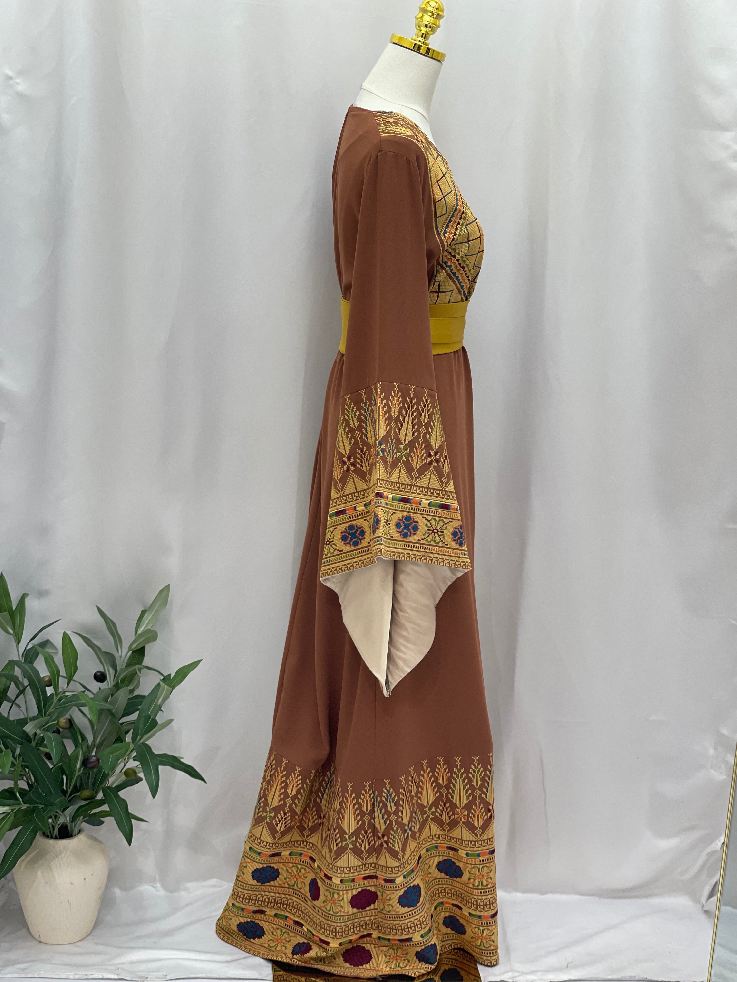Embroidered Palestinian thoub dress in brown with intricate traditional embroidery and yellow waist detail by Palestinian Elegance