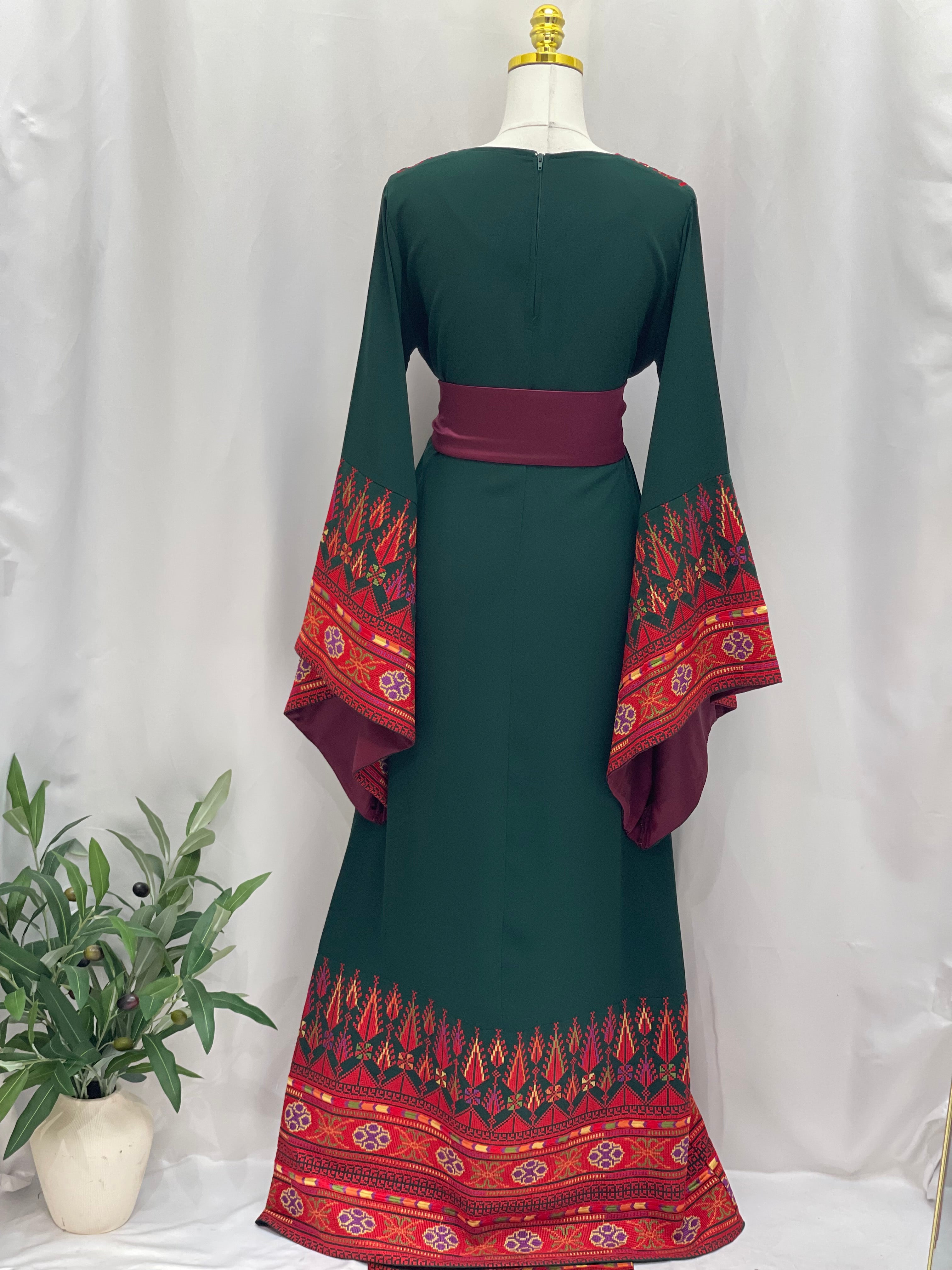 Embroidered Palestinian thoub dress with green fabric and red detailed embroidery on sleeves and hem