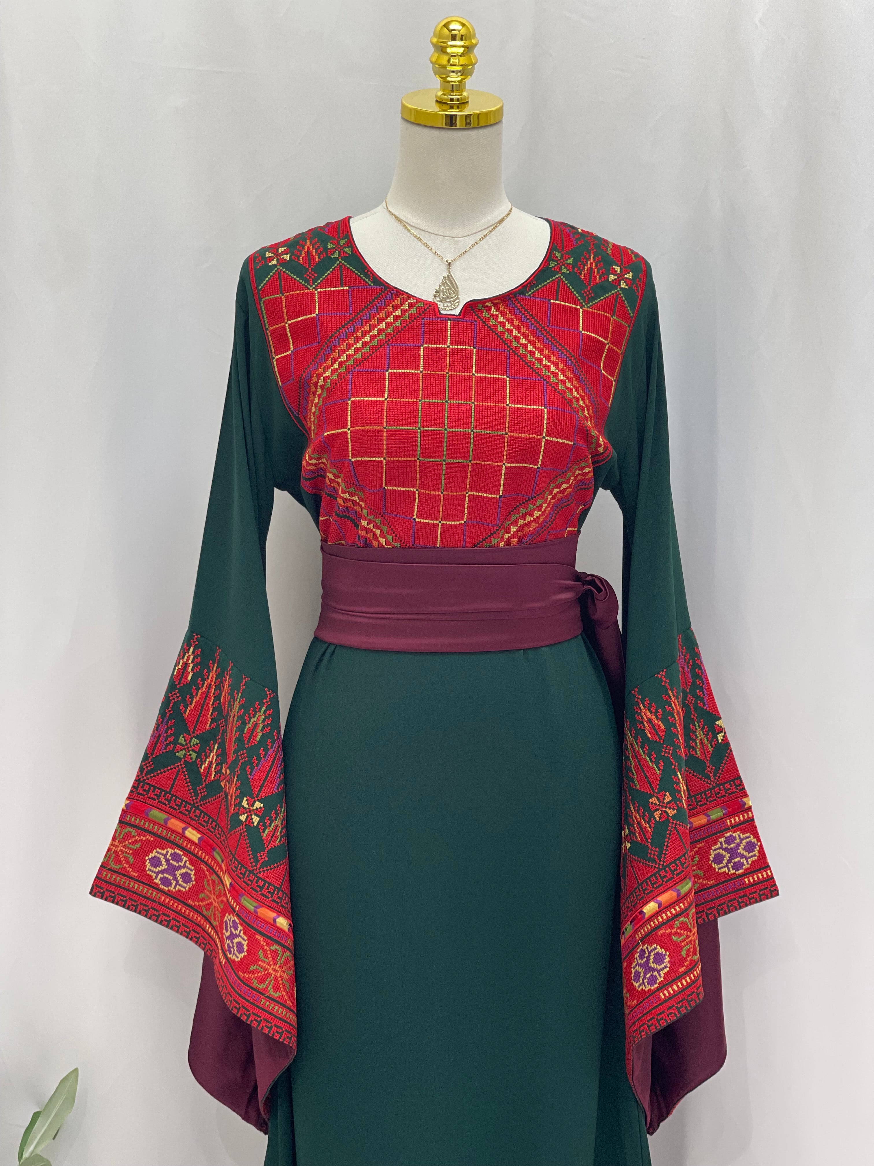 Embroidered Palestinian thoub dress by Palestinian Elegance with detailed red and green traditional patterns