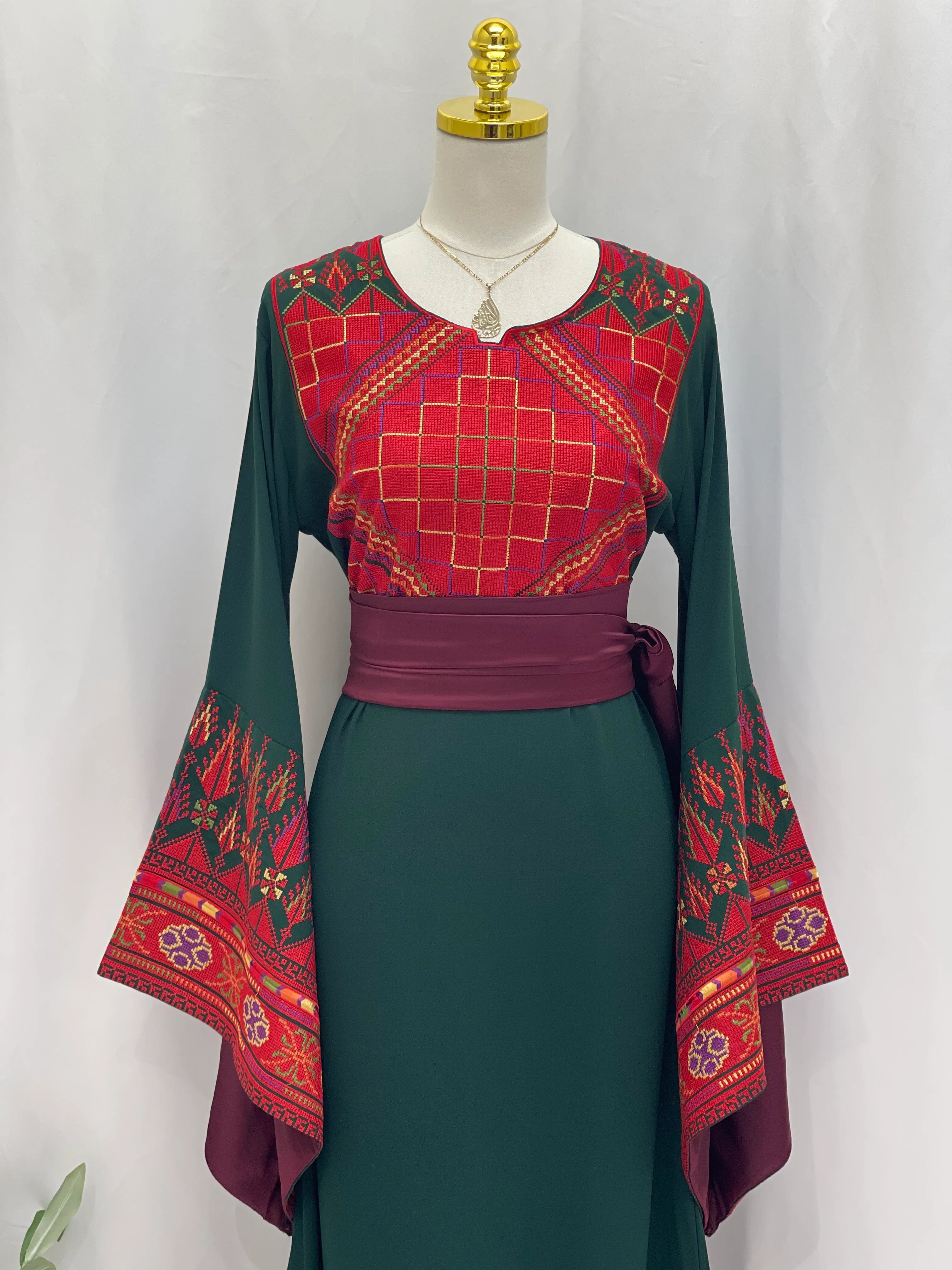 Embroidered Palestinian thoub dress by Palestinian Elegance with detailed red and green traditional patterns