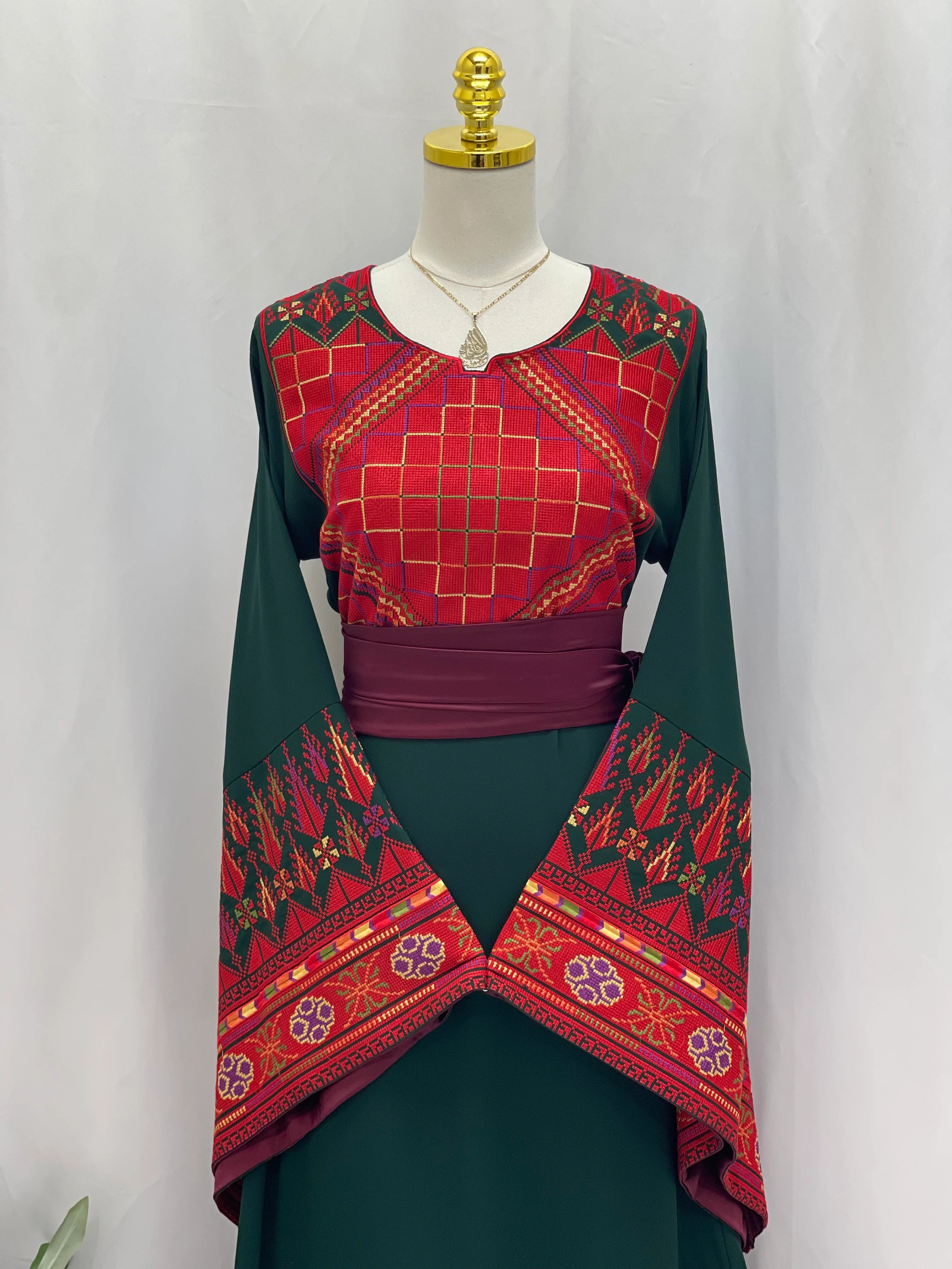 Embroidered Palestinian thoub dress by Palestinian Elegance with red and green traditional patterns quality