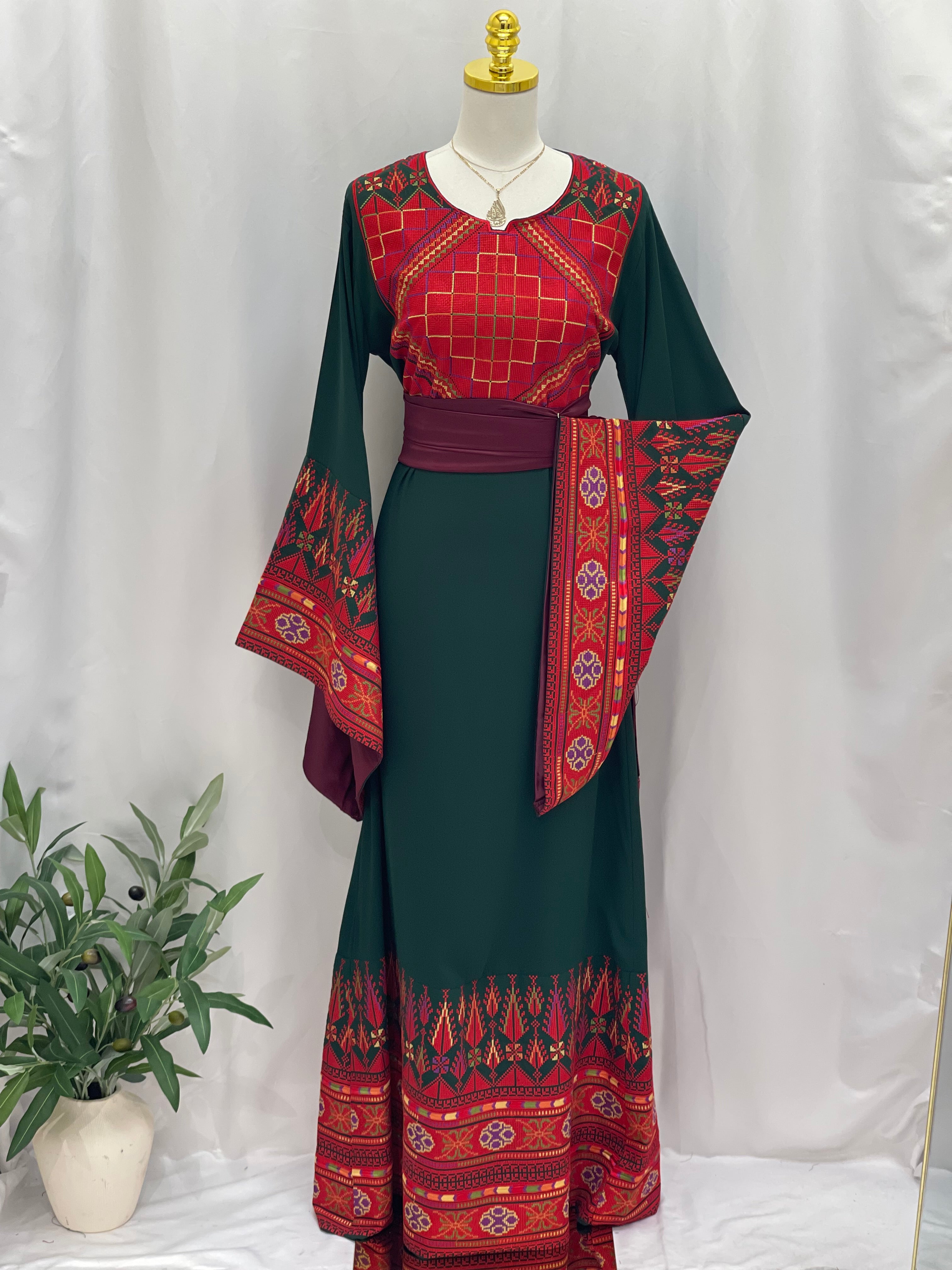 Embroidered Palestinian thoub dress by Palestinian Elegance with red and green traditional patterns