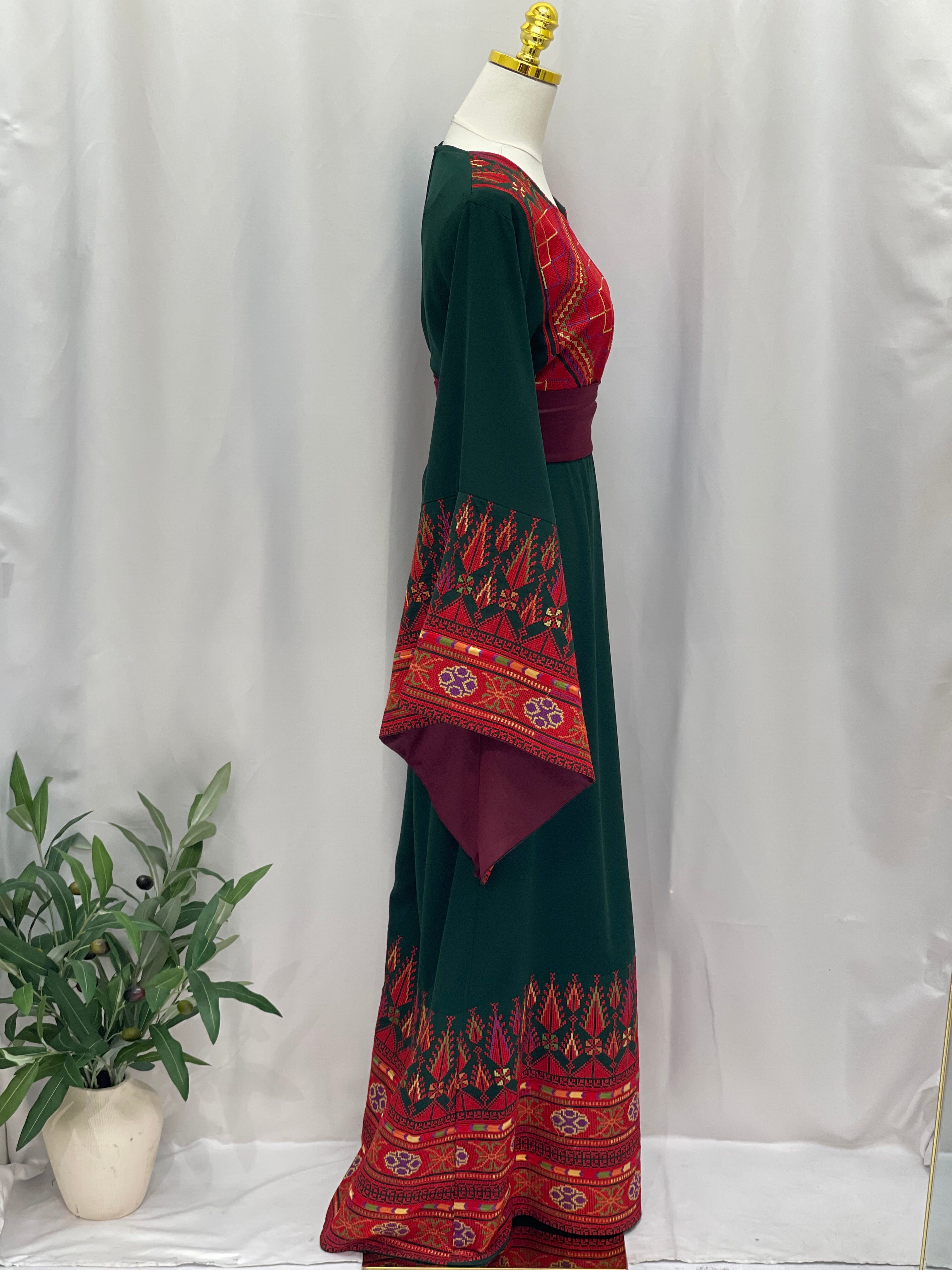 Embroidered Palestinian thoub dress by Palestinian Elegance with red and green traditional patterns precise