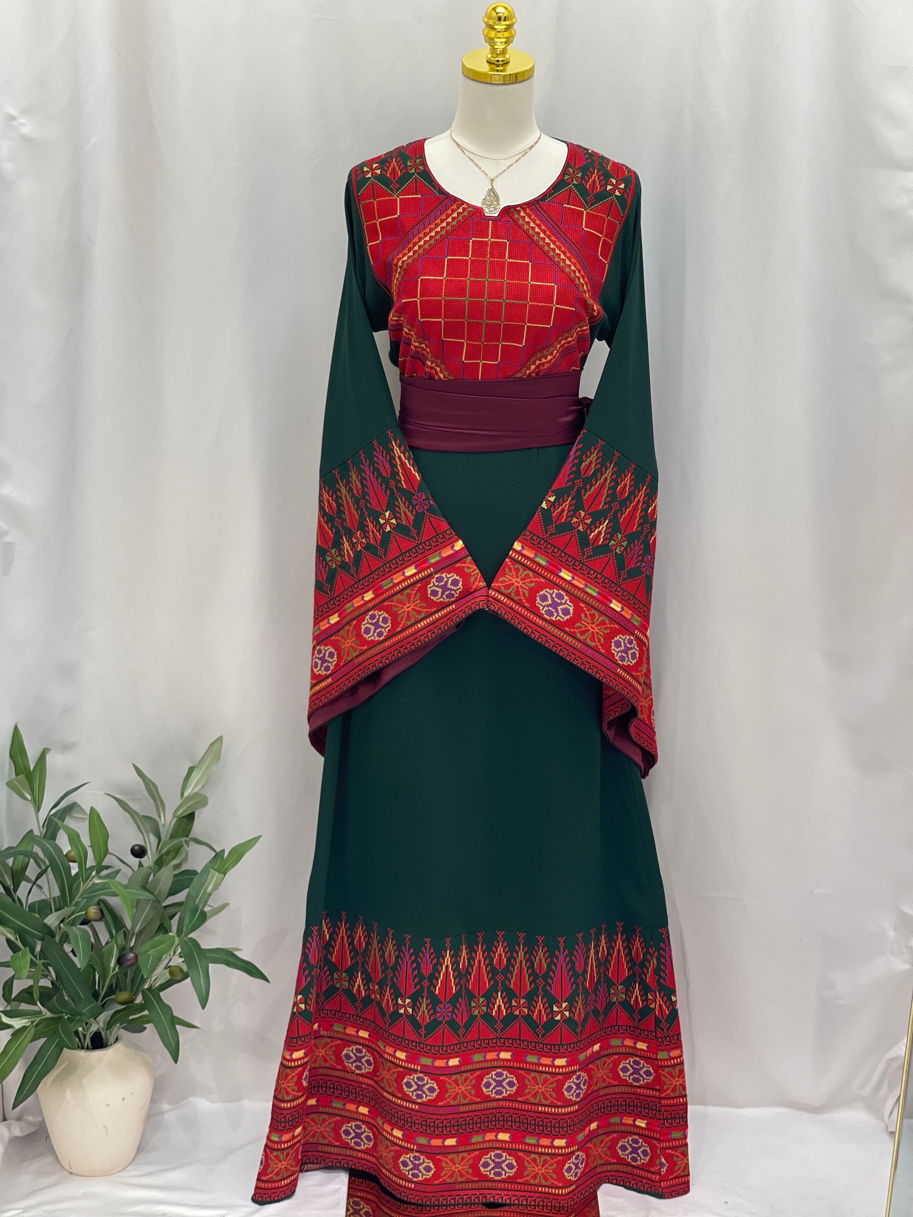 Embroidered Palestinian thoub dress by Palestinian Elegance in green and red with traditional patterns and wide sleeves