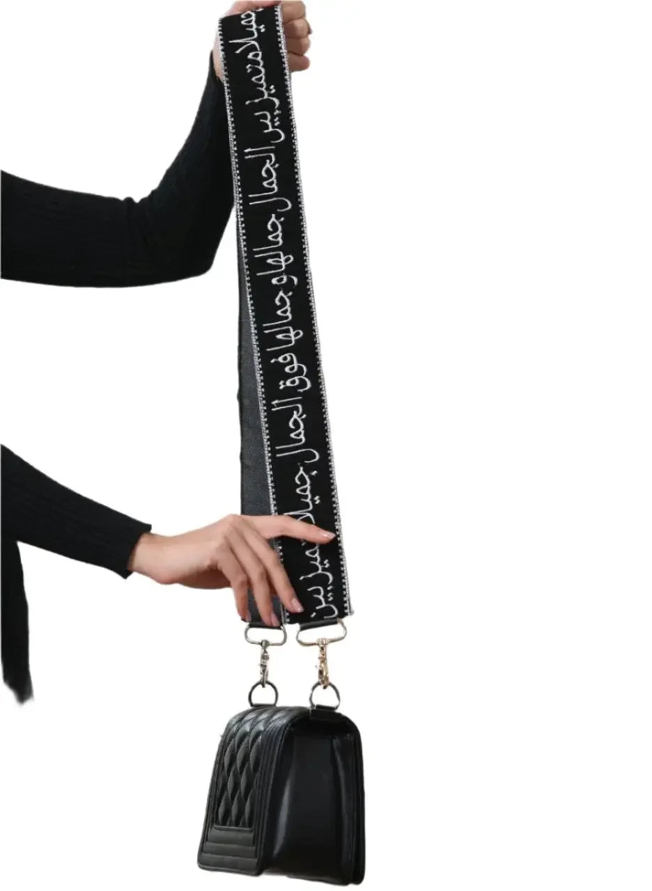Palestinian Elegance black embroidered purse with poetic strap featuring Arabic calligraphy design