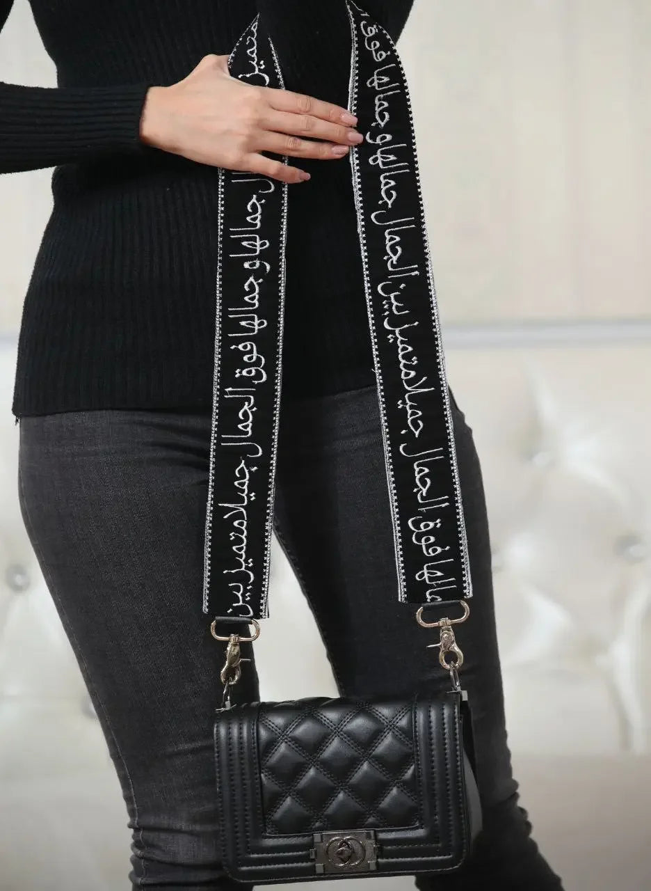 Palestinian Elegance embroidered purse with poetic strap in black featuring white Arabic calligraphy