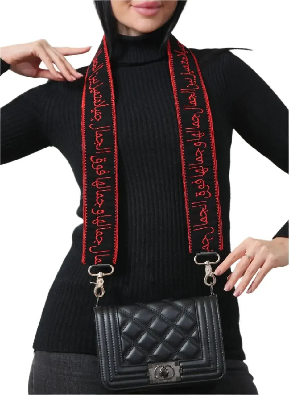 Black quilted handbag with embroidered purse with poetic strap in red and black worn over shoulder