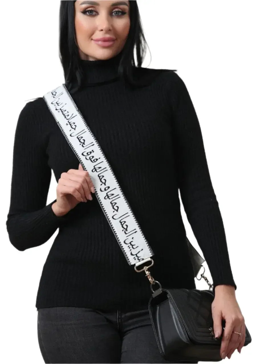 Embroidered purse with poetic strap worn by woman in black sweater from Palestinian Elegance