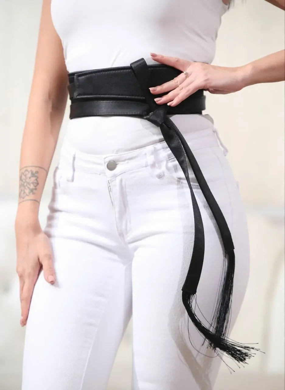 Black embroidered satin belt from Palestinian Elegance styled over white jeans and a white top