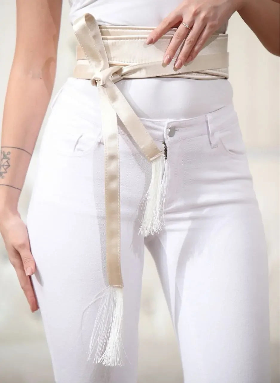Palestinian Elegance embroidered satin belt in beige wrapped around waist with decorative white tassels