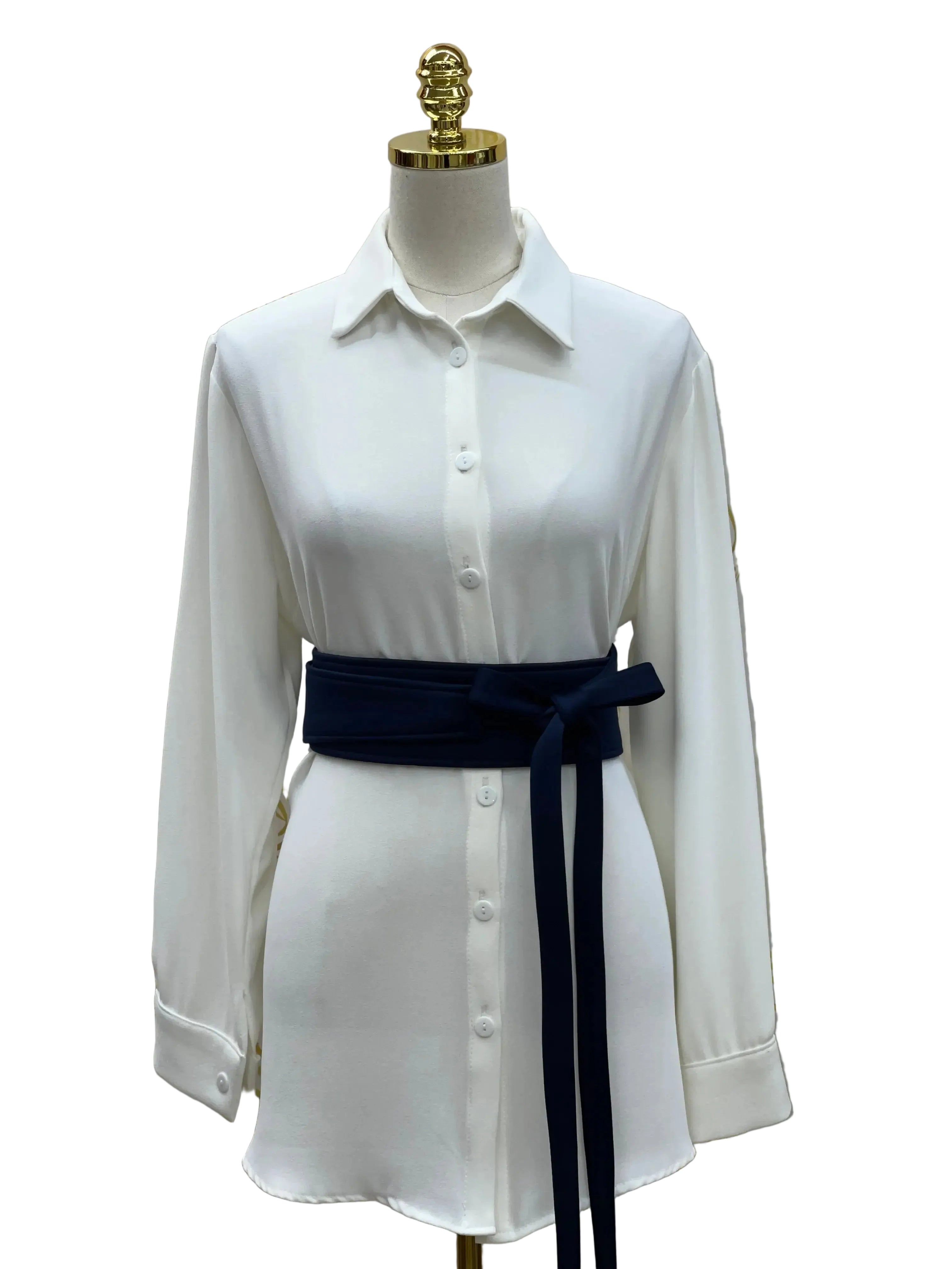 White button-up shirtdress styled with a navy embroidered satin belt by Palestinian Elegance
