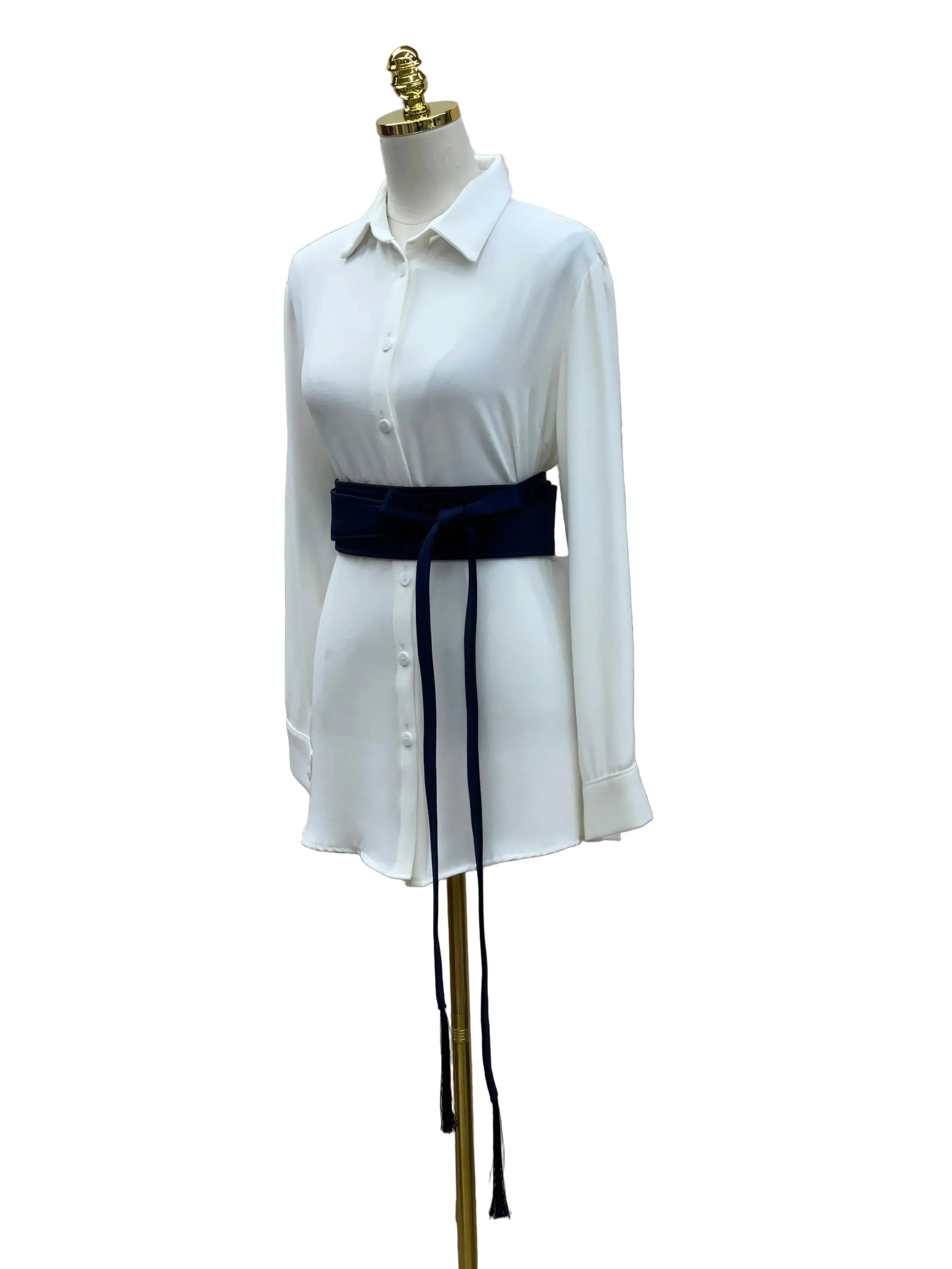 Palestinian Elegance embroidered satin belt in navy blue worn over white long sleeve shirt on mannequin