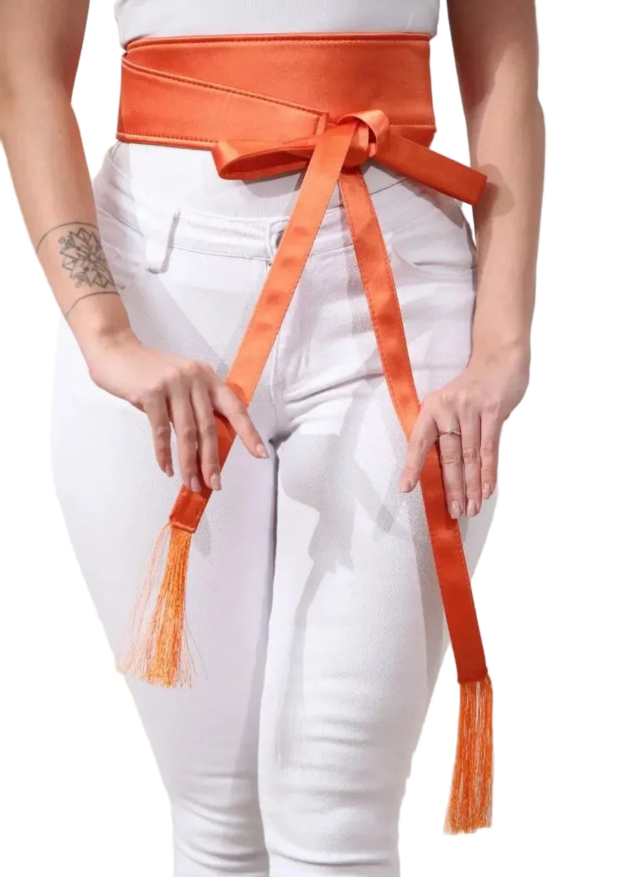 Embroidered satin belt in vibrant orange wrapped around waist with tassels by Palestinian Elegance