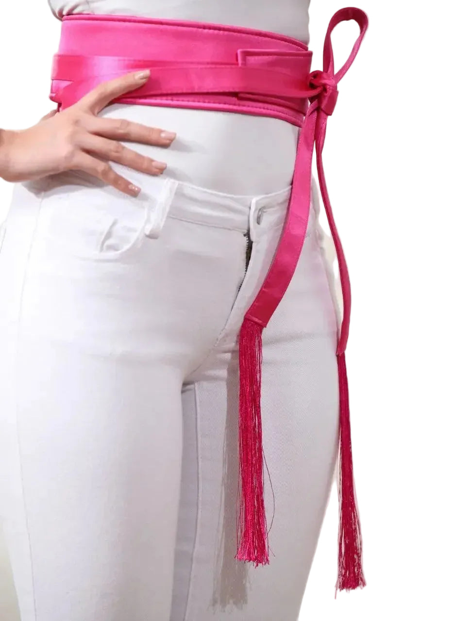 Pink embroidered satin belt wrapped and tied with tassels styled over white pants