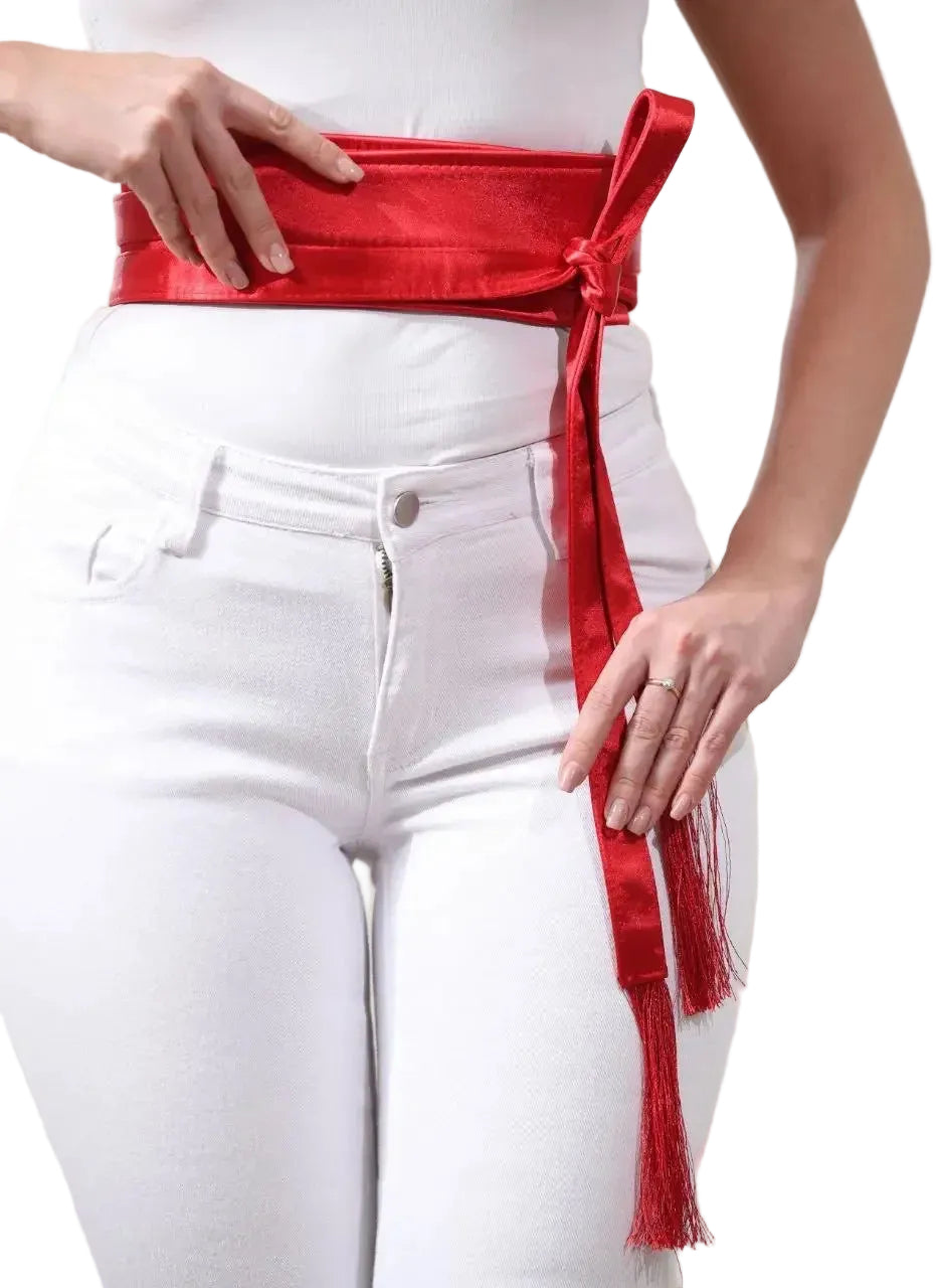 Red embroidered satin belt tied around waist over white pants from Palestinian Elegance accessories
