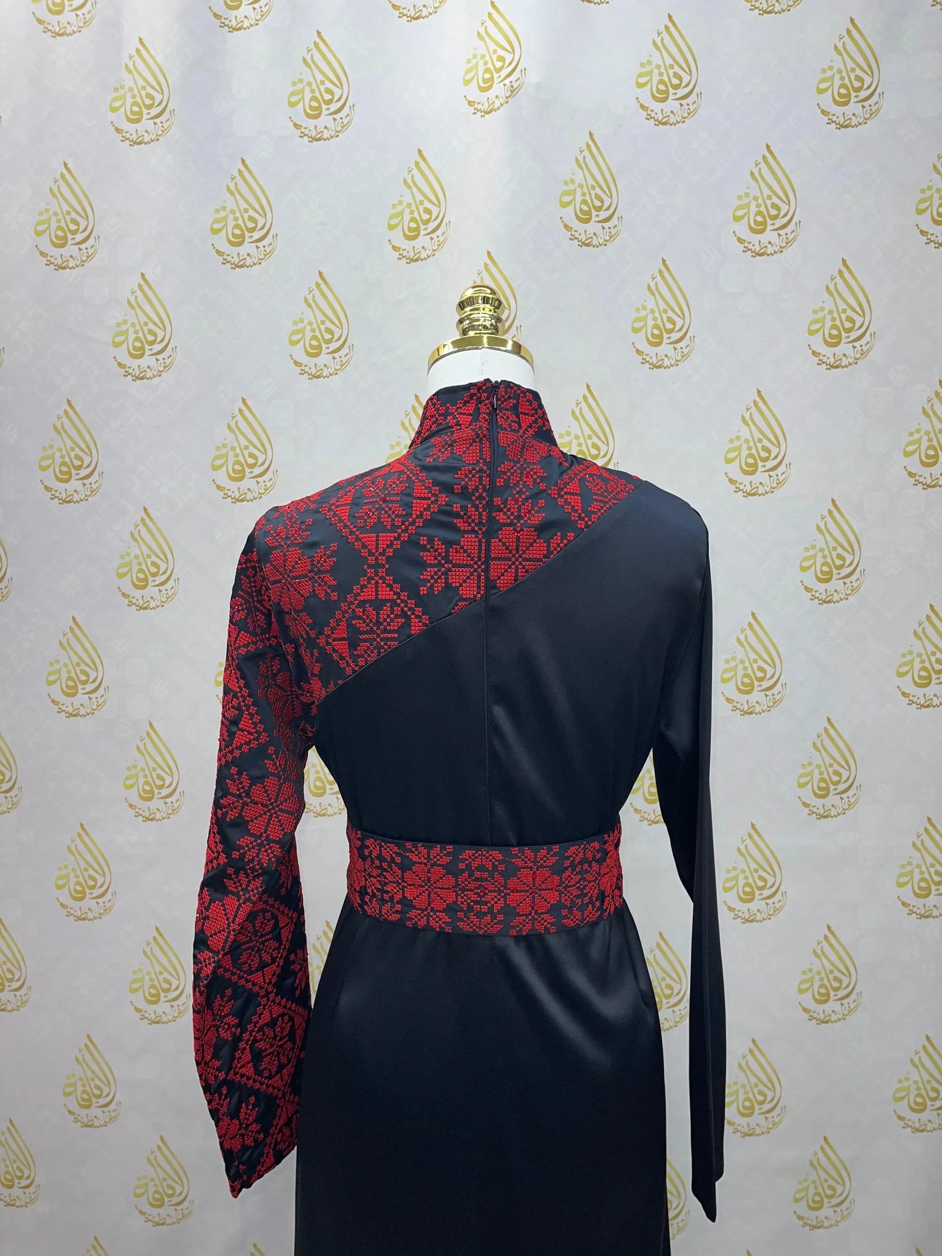 Palestinian Elegance embroidered satin dress in black with red intricate embroidery on sleeve, upper back, and waist