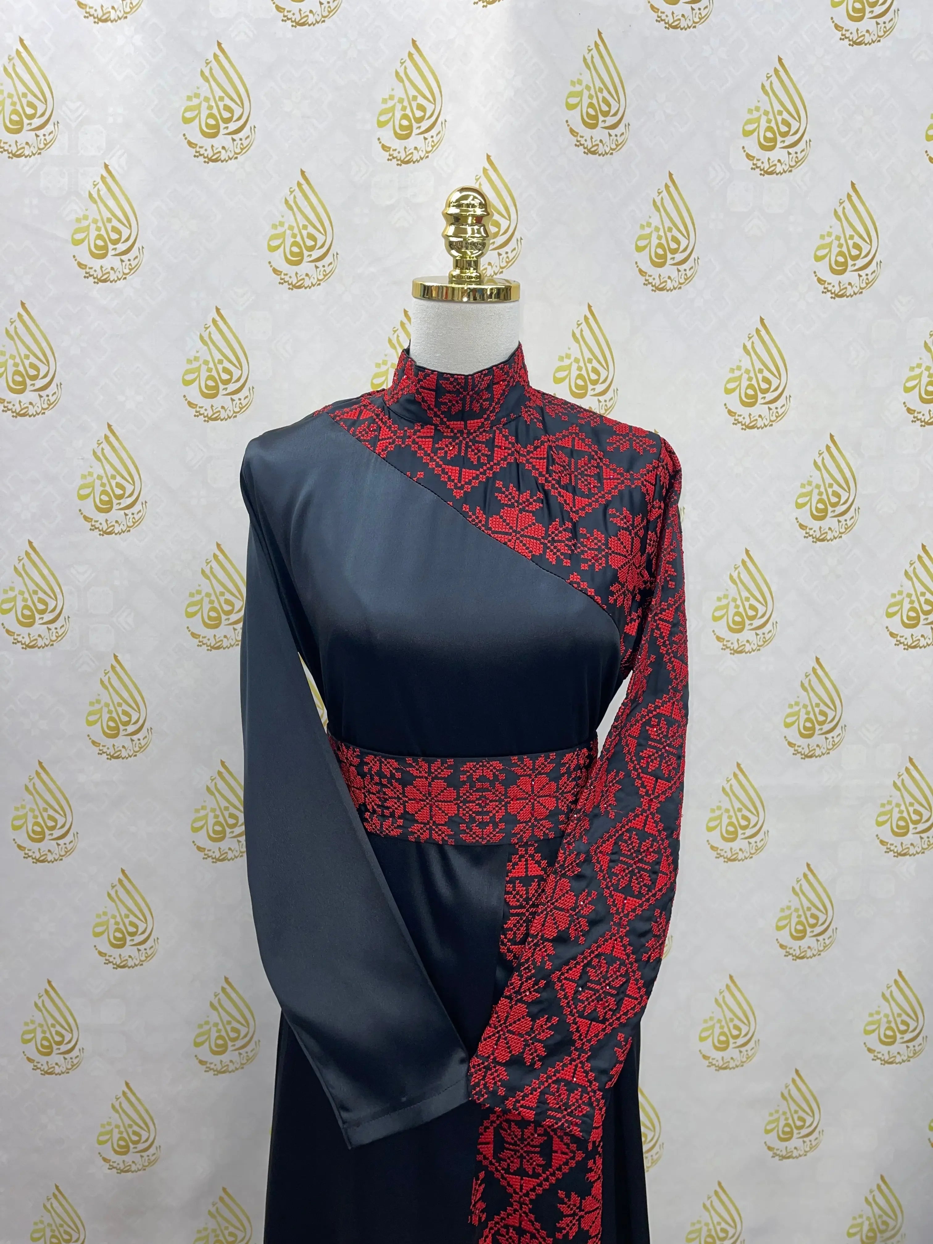 Palestinian Elegance embroidered satin dress in black with red traditional embroidery on sleeve and chest