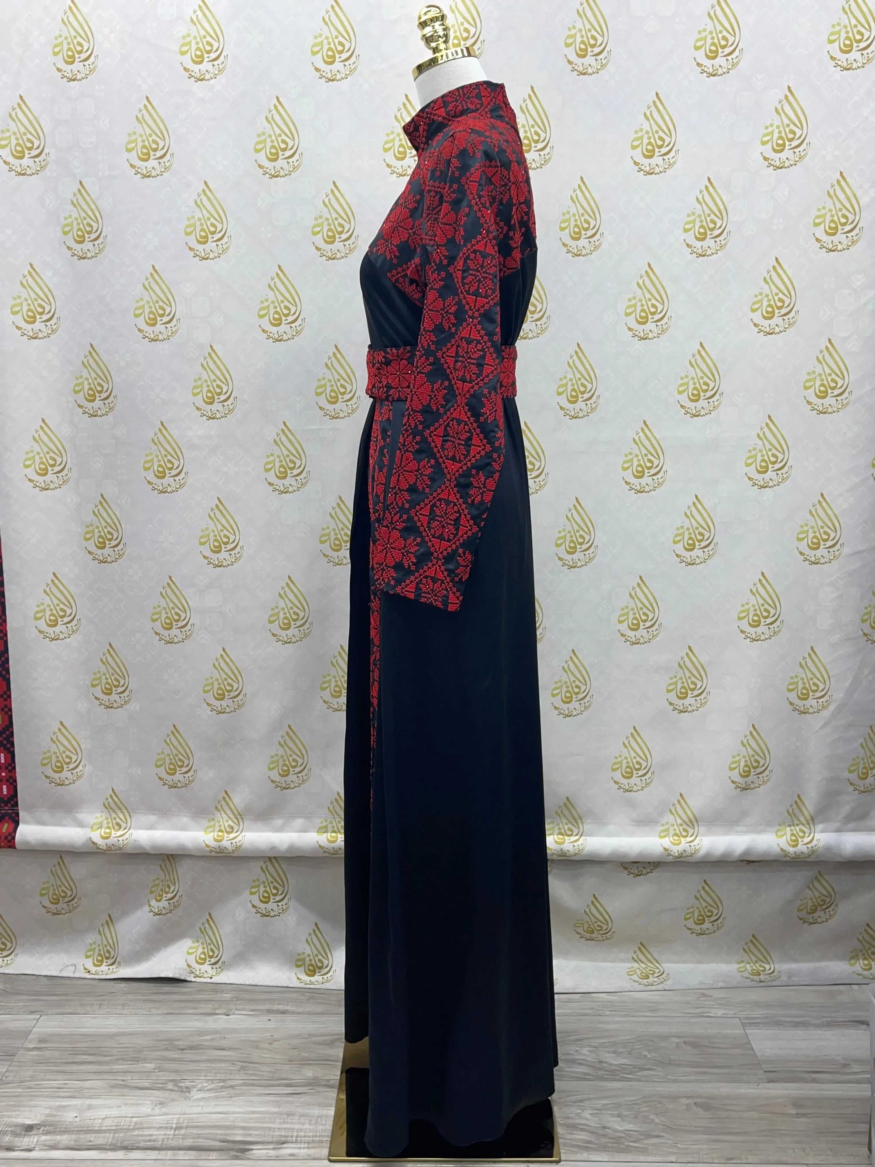 Palestinian Elegance embroidered satin dress in black with red traditional embroidery on sleeves and collar
