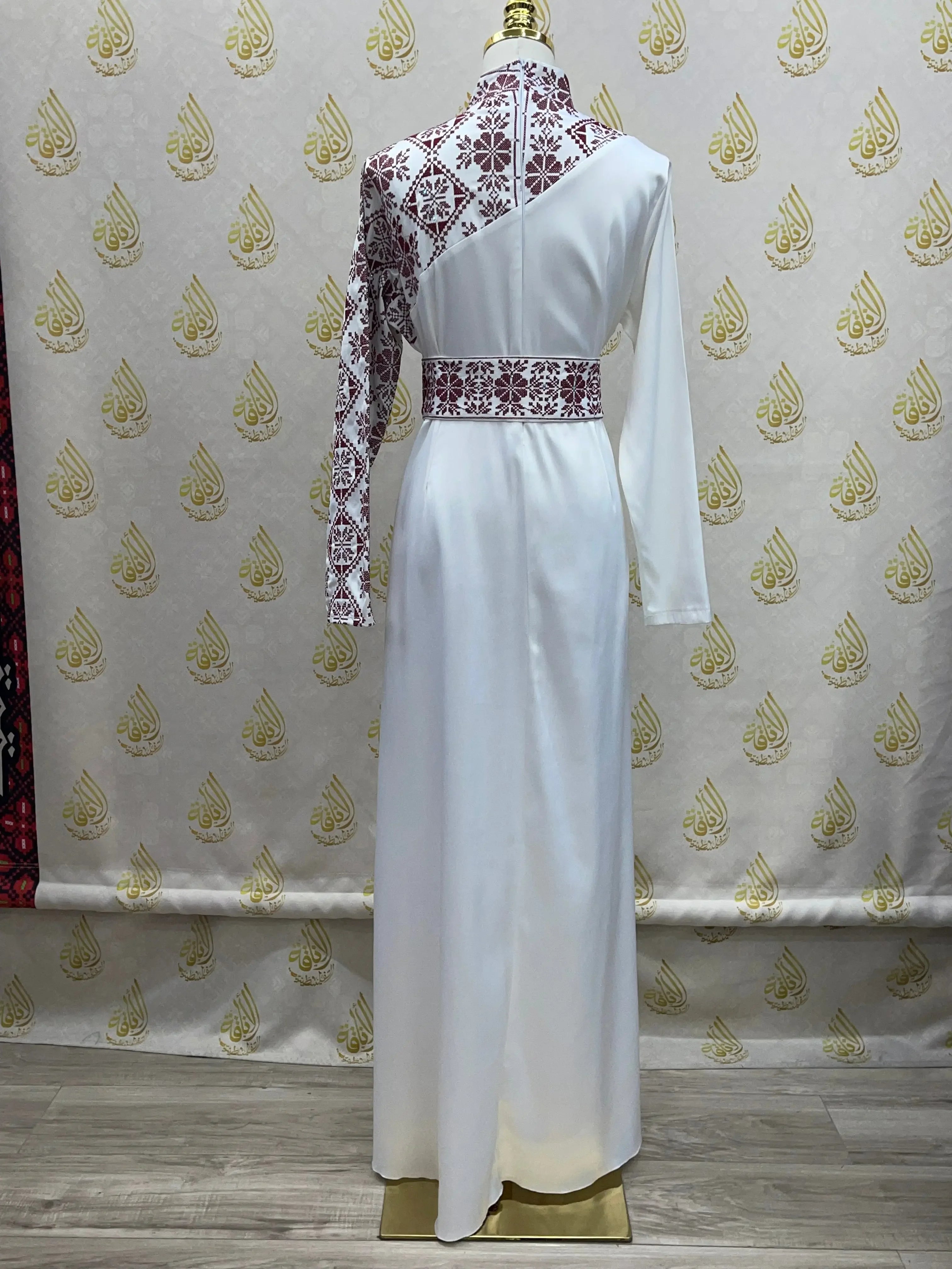 Palestinian Elegance embroidered satin dress with white fabric and intricate maroon embroidery on one sleeve and back