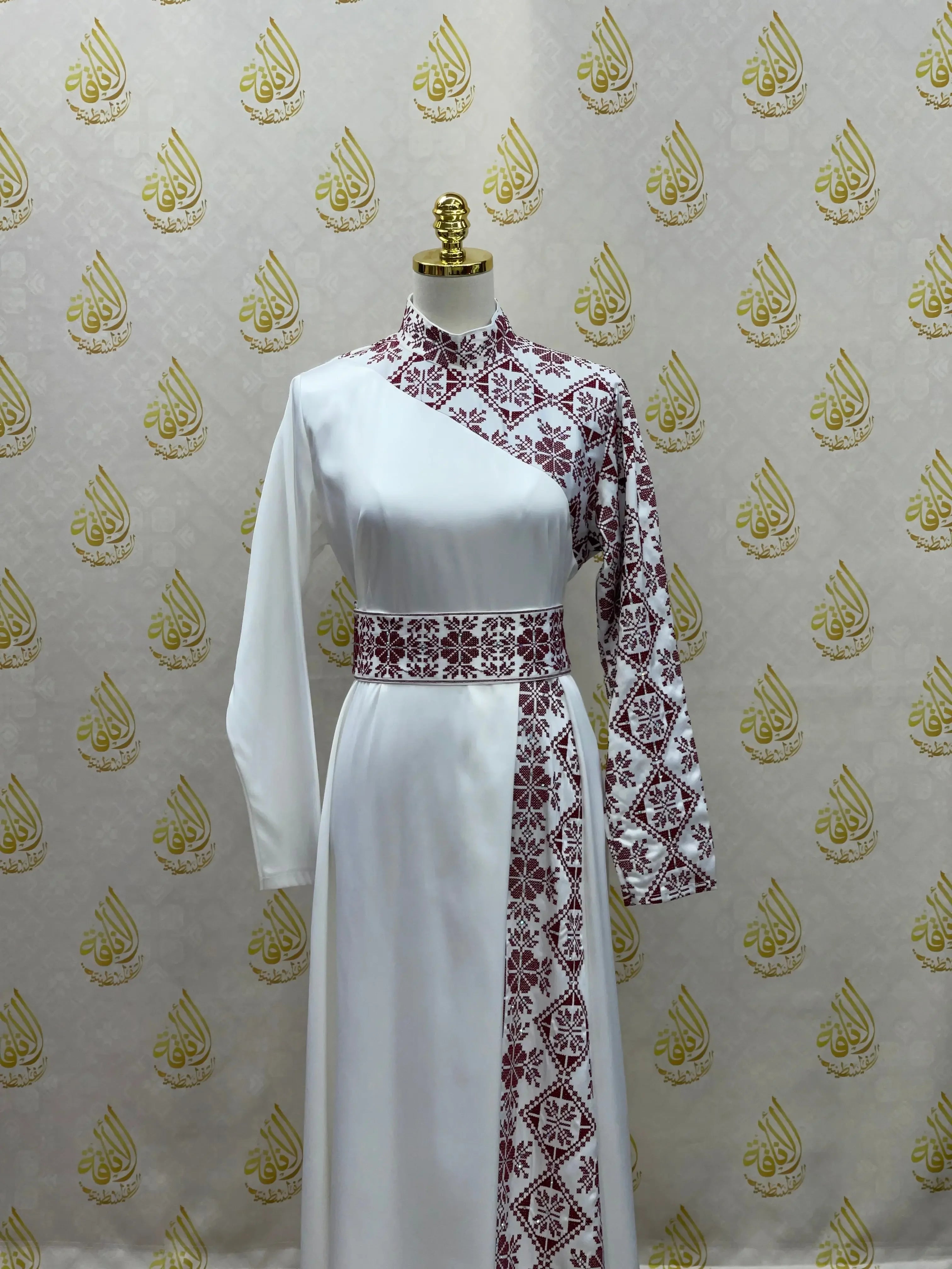 Palestinian Elegance embroidered satin dress with white fabric and maroon traditional cross-stitch patterns