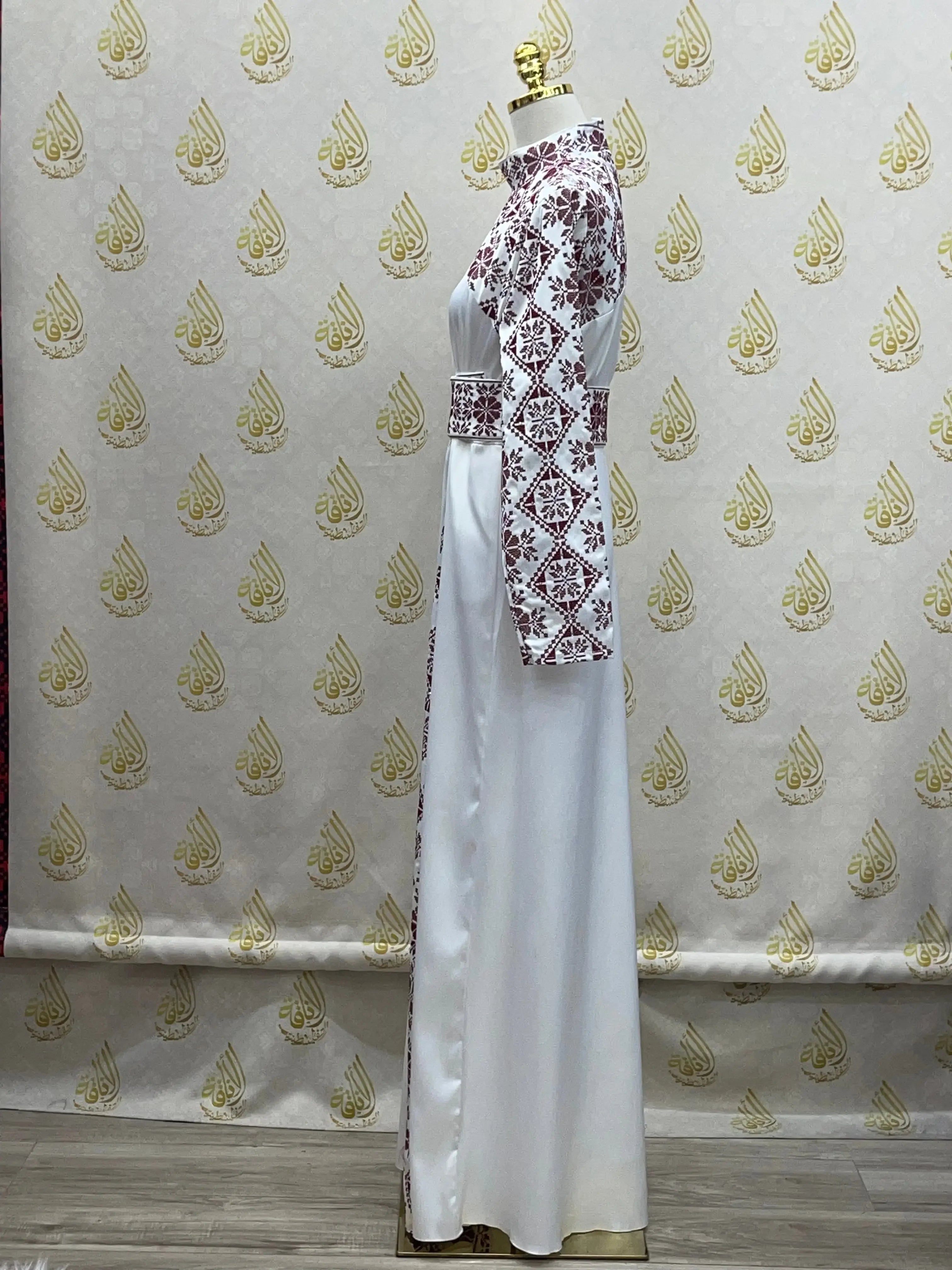 Palestinian Elegance embroidered satin dress with traditional red embroidery on sleeves and waist