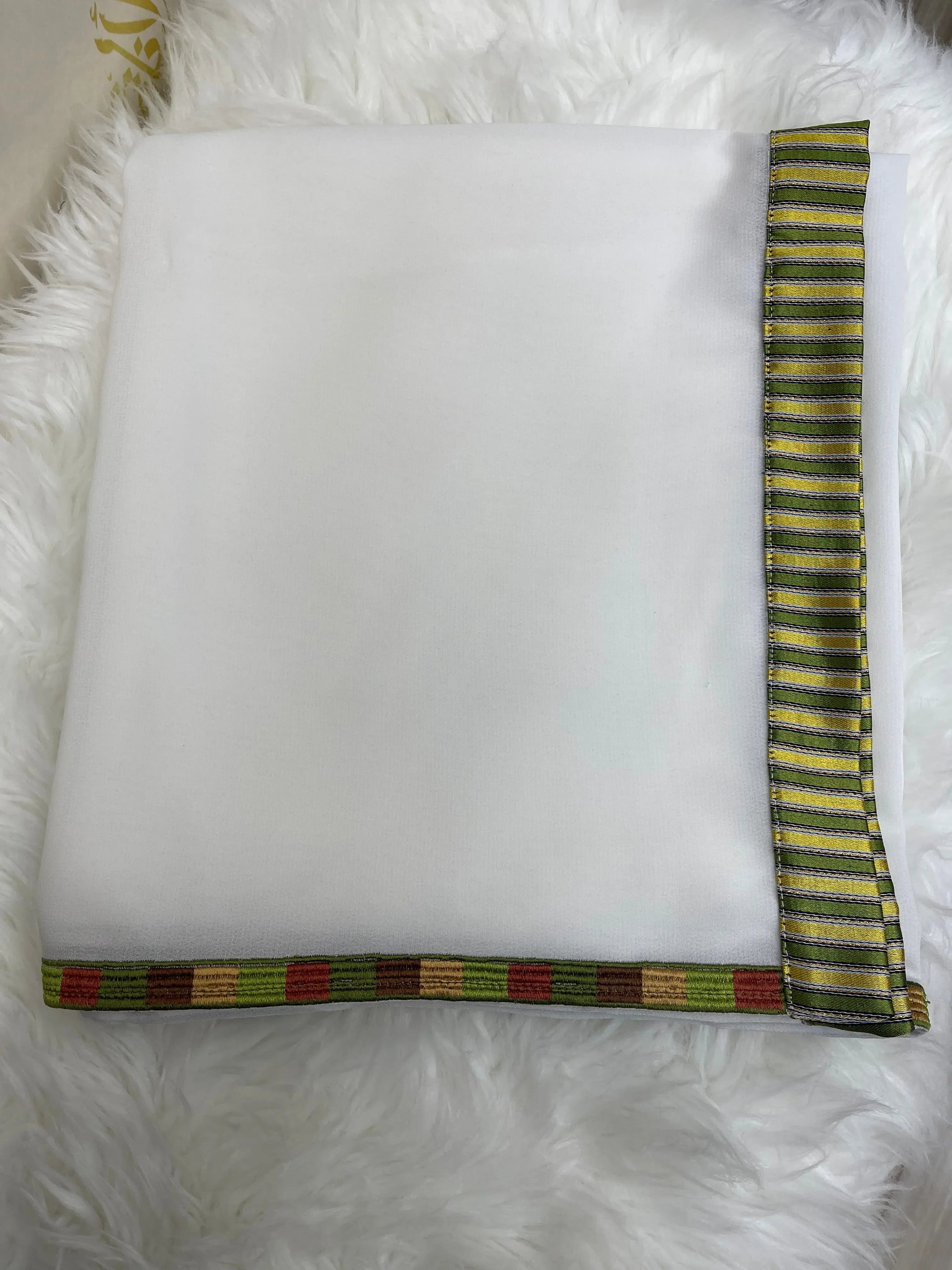 White embroidered saya khirka shawl with colorful striped border from Palestinian Elegance