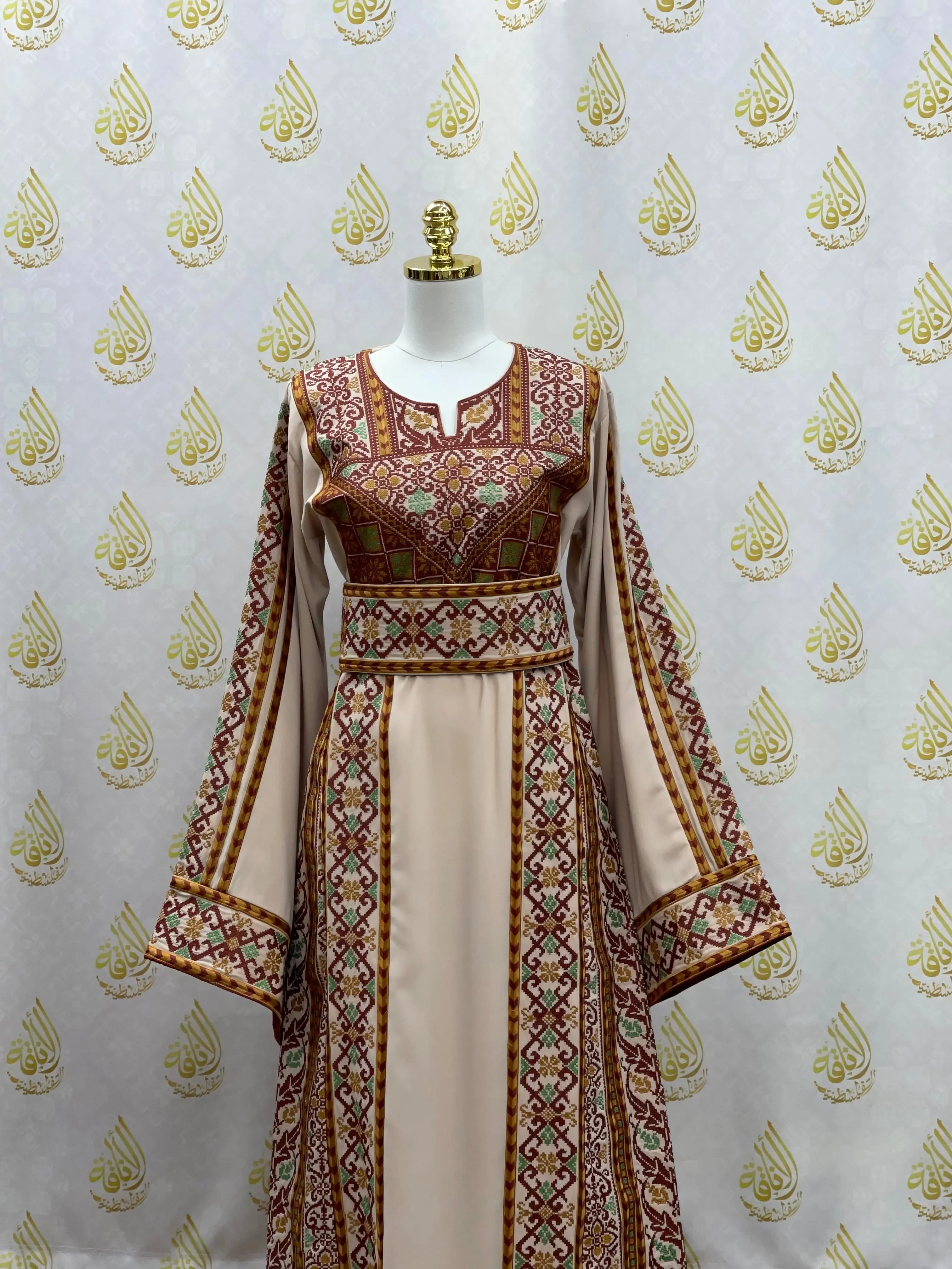 Palestinian Elegance embroidered thoub dress with intricate maroon and gold embroidery on beige fabric