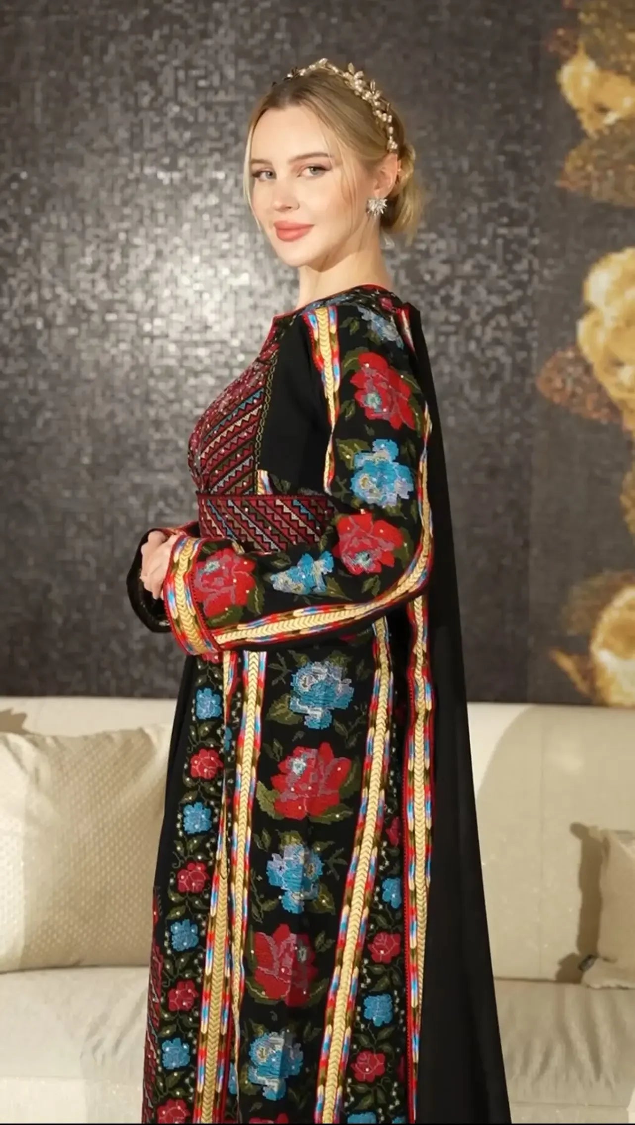 Palestinian Elegance embroidered thoub dress featuring vibrant red and blue floral embroidery on black fabric