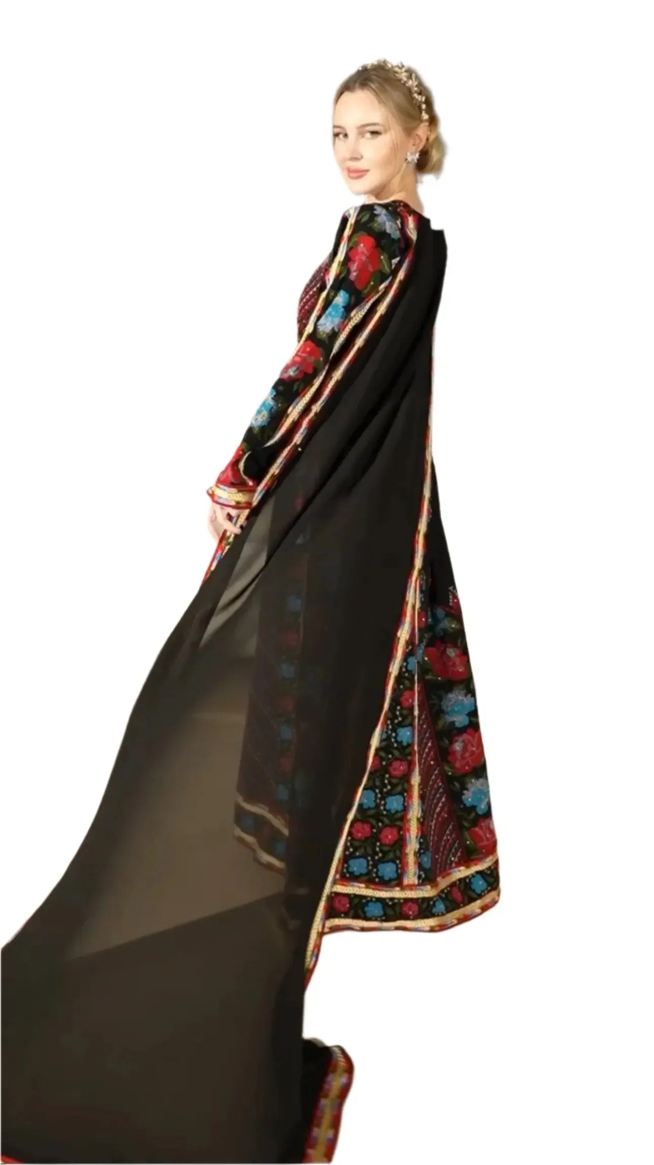 Woman wearing a black embroidered thoub dress with colorful floral patterns and flowing sheer fabric