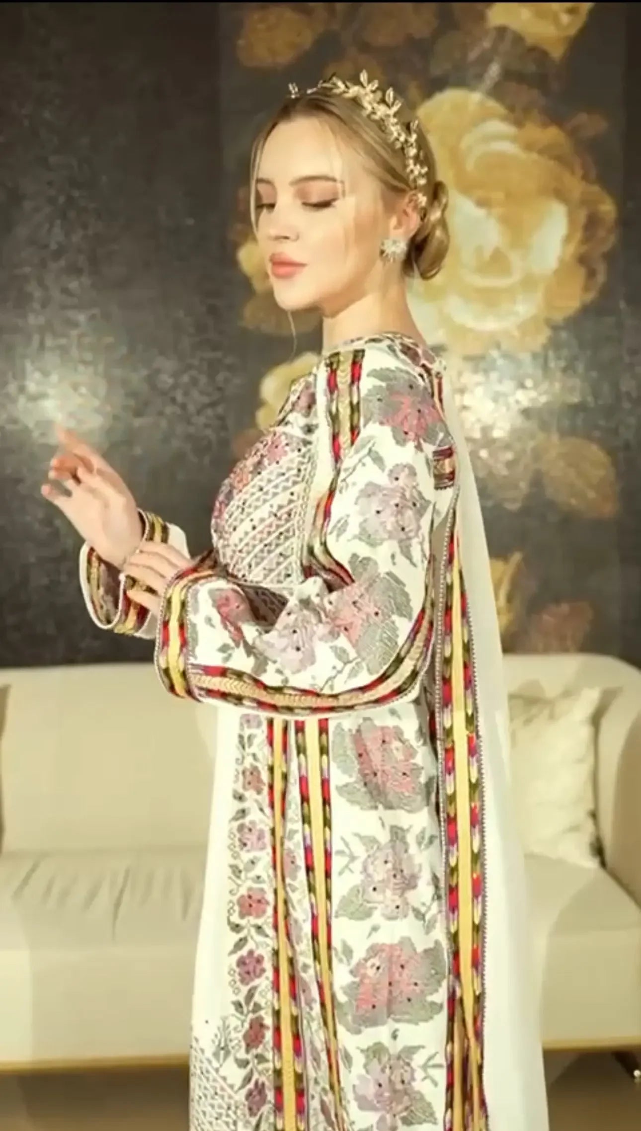 Woman wearing a Palestinian Elegance embroidered thoub dress with intricate floral patterns and elegant details