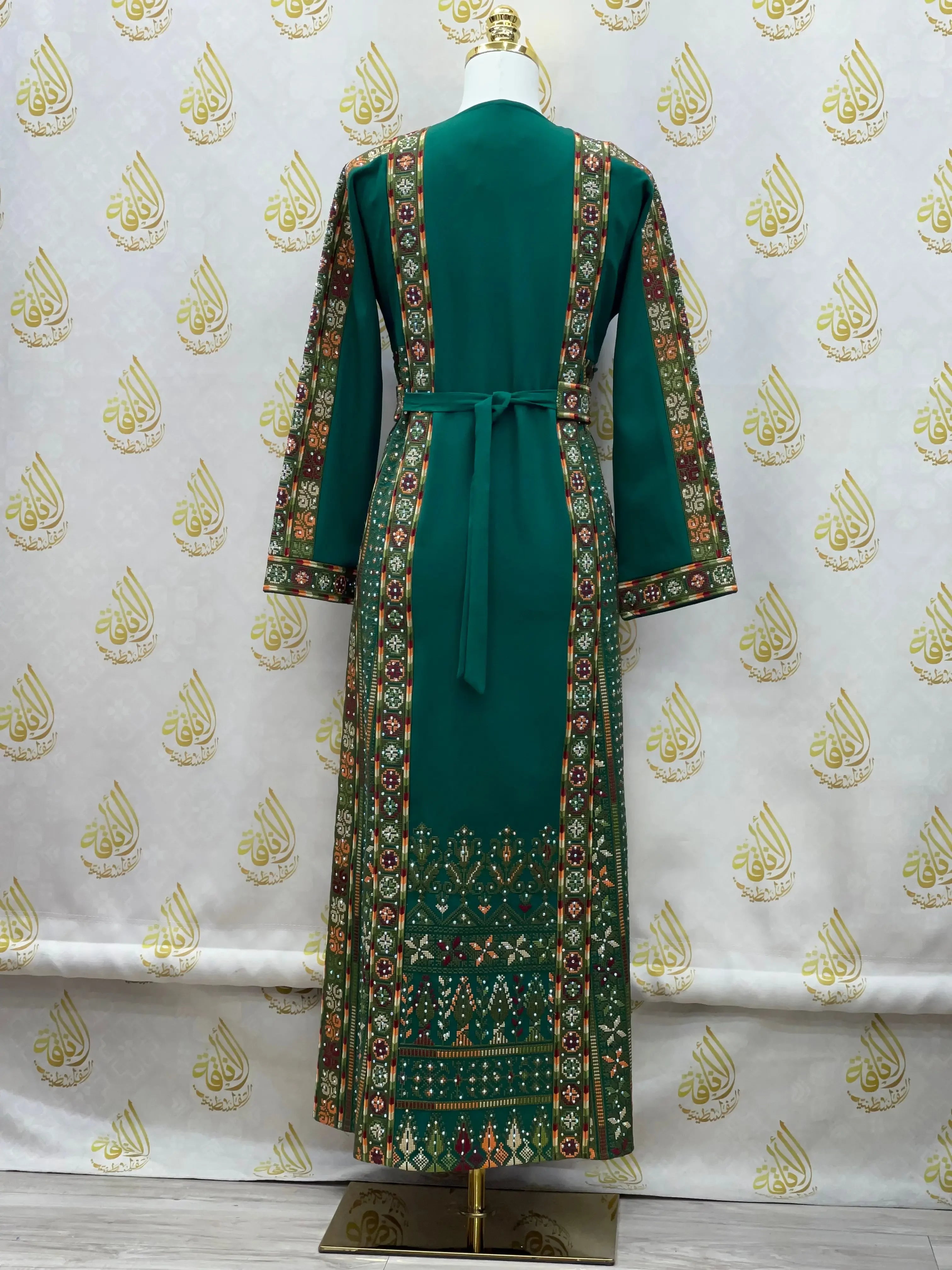 Green embroidered thoub for girls with intricate traditional Palestinian patterns and long sleeves
