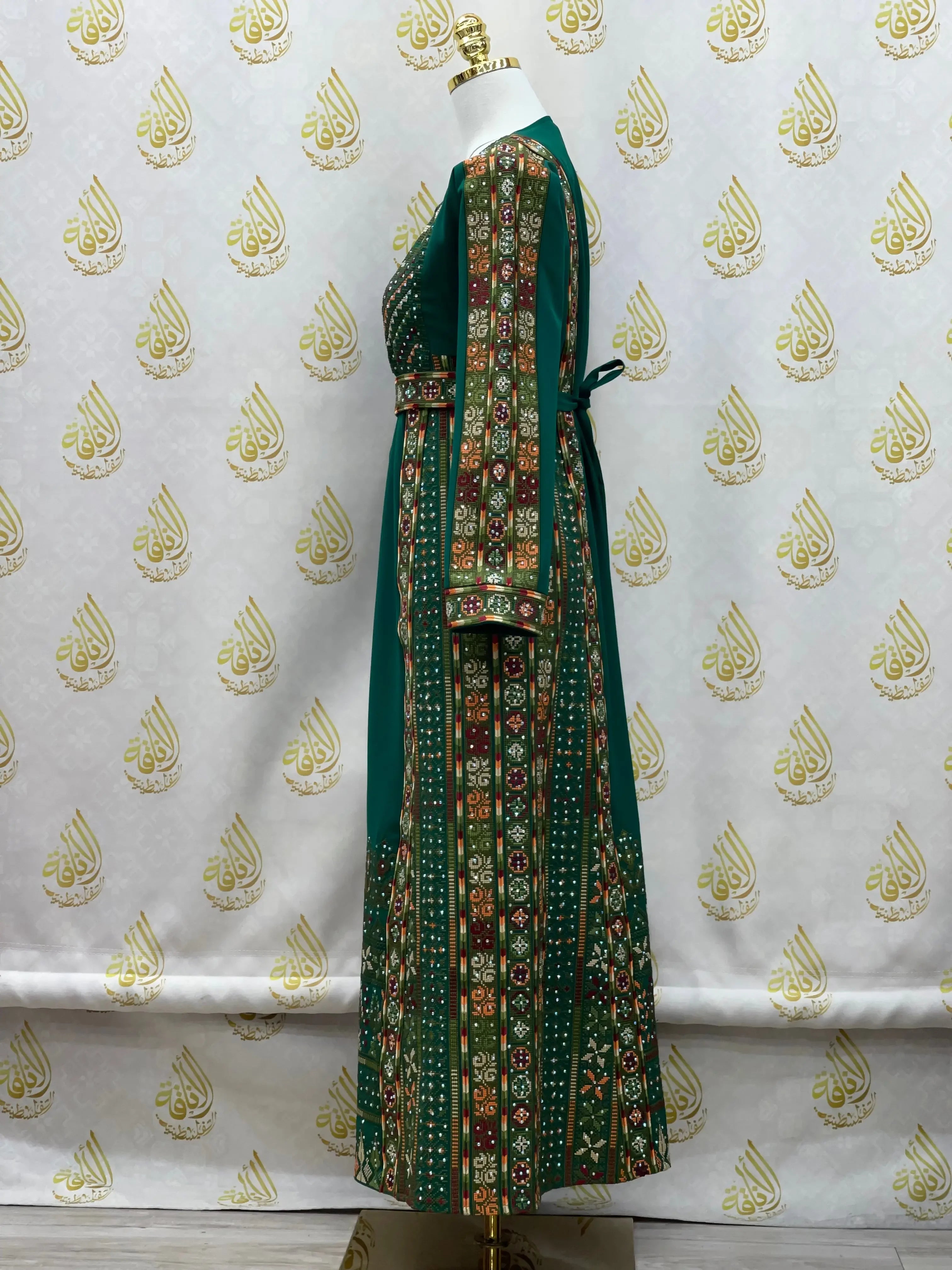 Green embroidered thoub for girls with traditional intricate patterns by Palestinian Elegance