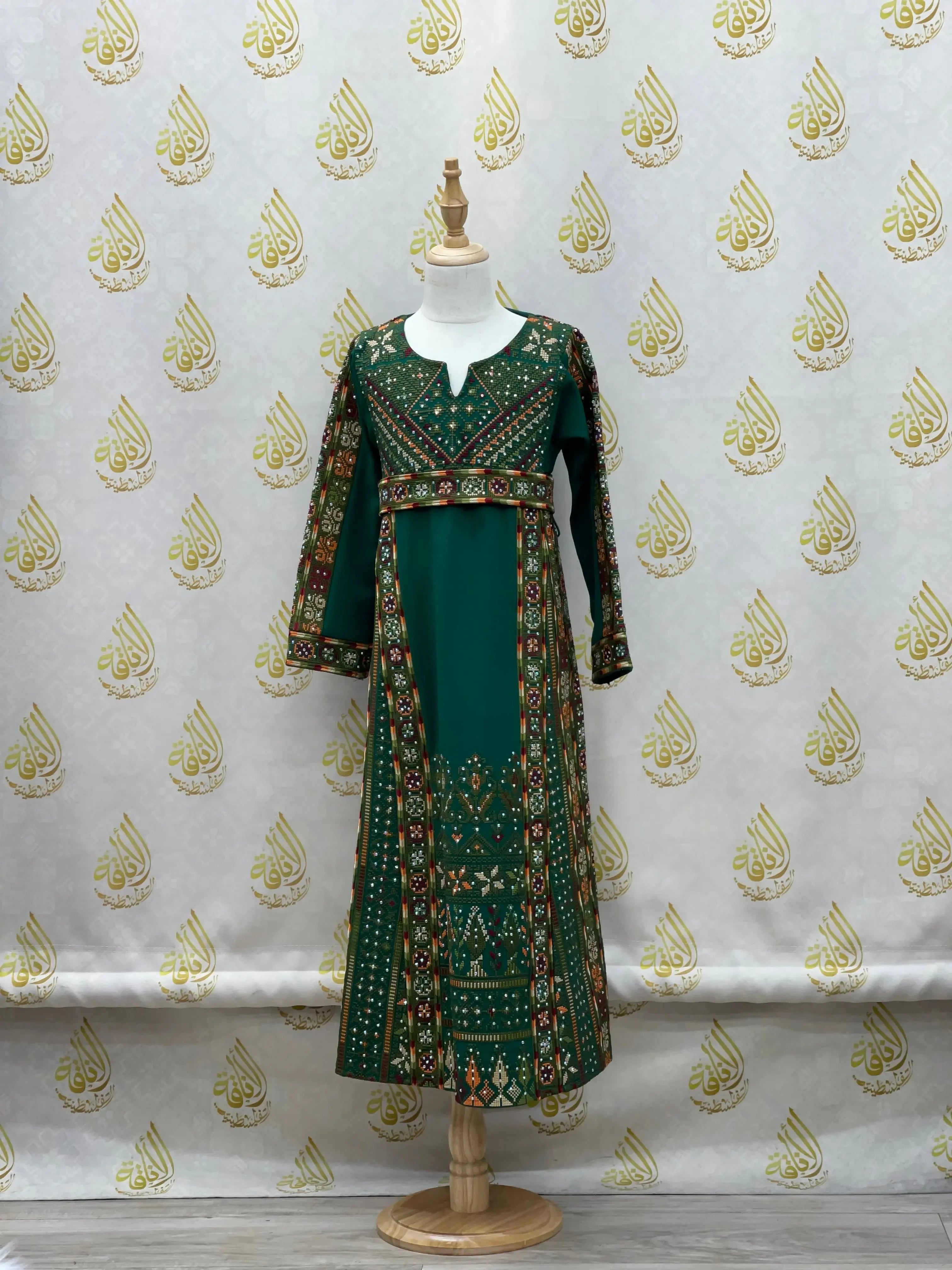 Green embroidered thoub for girls with traditional Palestinian patterns by Palestinian Elegance