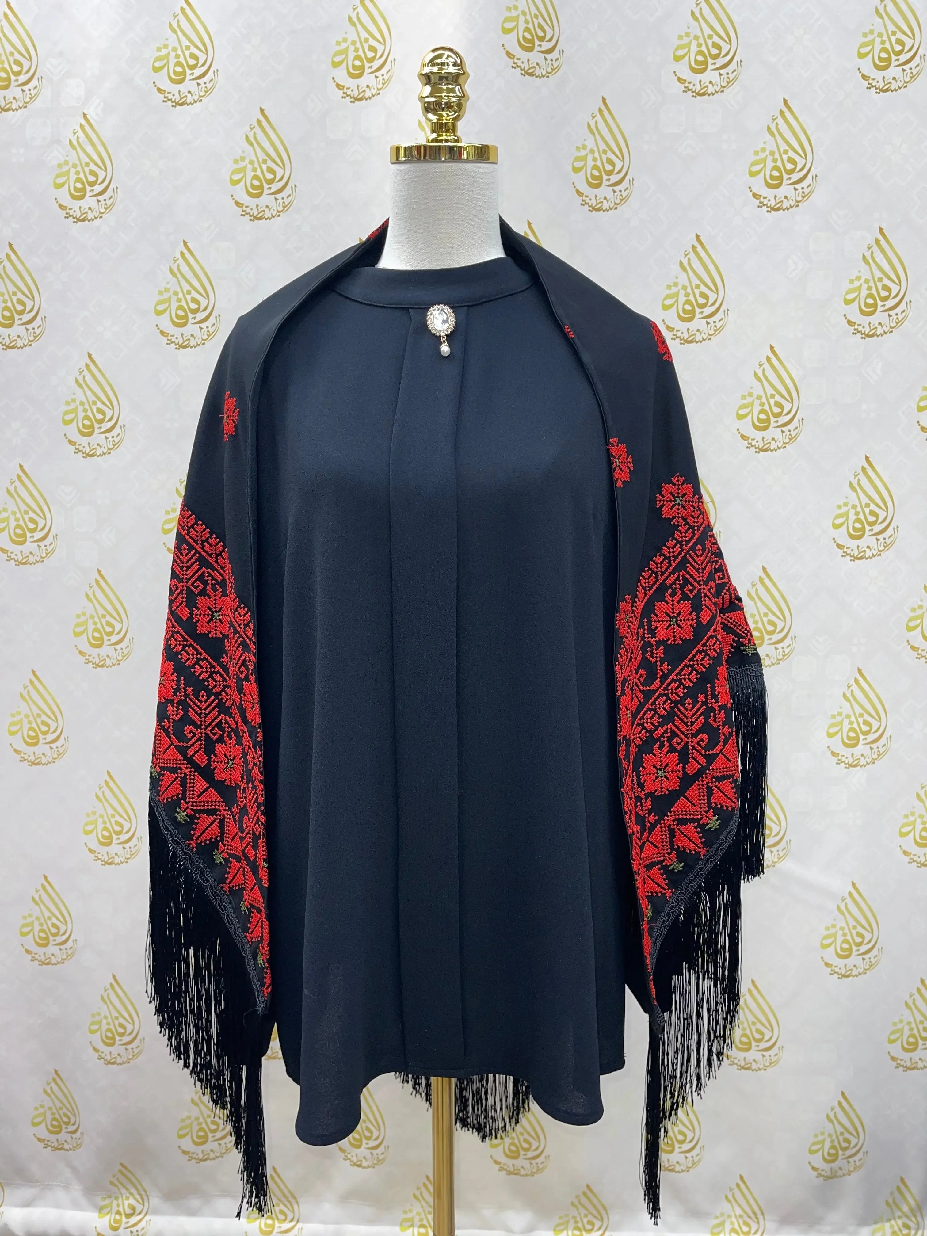 Palestinian Elegance embroidered triangle shawl in black with red traditional designs and fringe edges