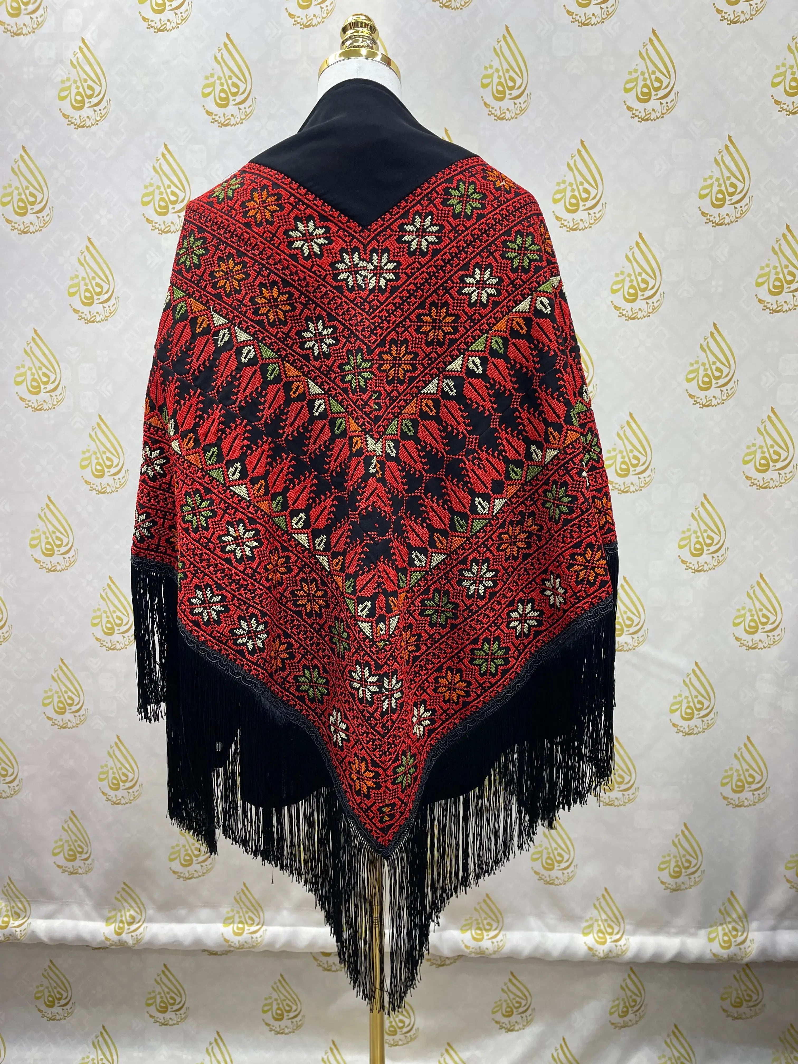Palestinian Elegance embroidered triangle shawl in red and black with floral and geometric patterns and fringe edges
