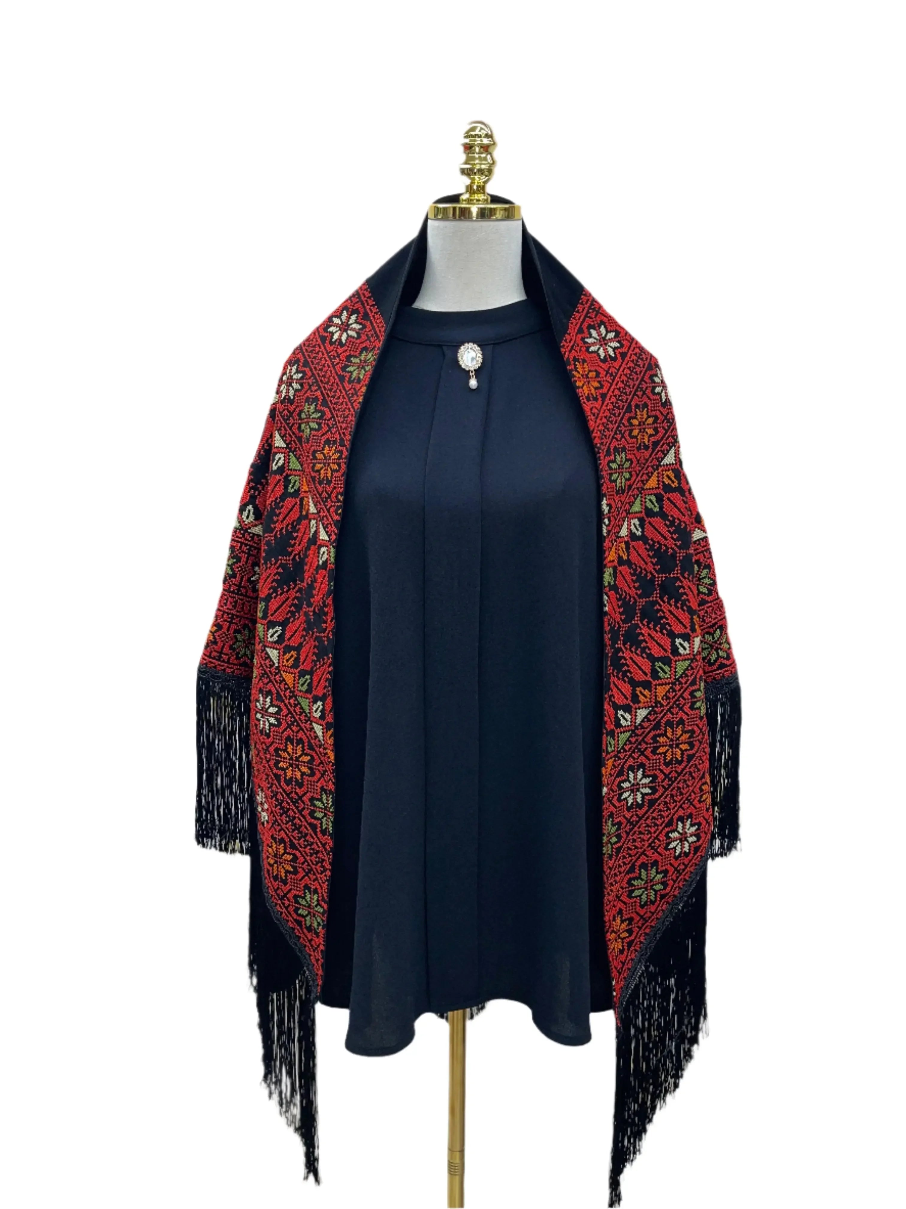 Palestinian Elegance embroidered triangle shawl in red and black with floral patterns and fringe detailing