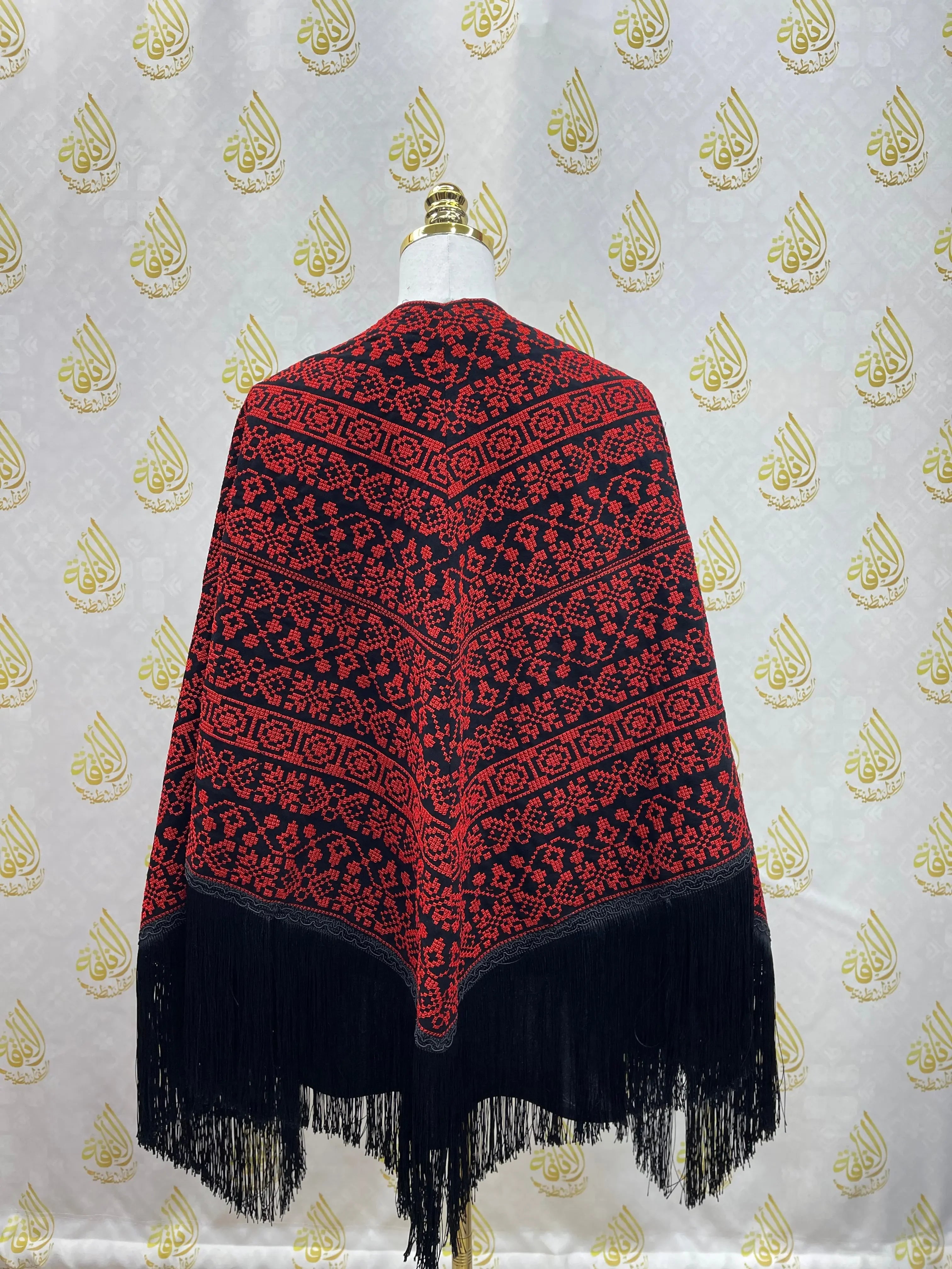 Palestinian Elegance embroidered triangle shawl with red and black intricate patterns and fringed edges