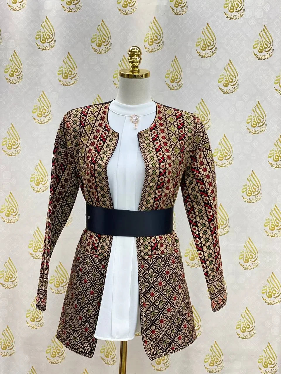 Palestinian Elegance embroidered women's jacket with intricate red and black geometric designs and a black waist belt